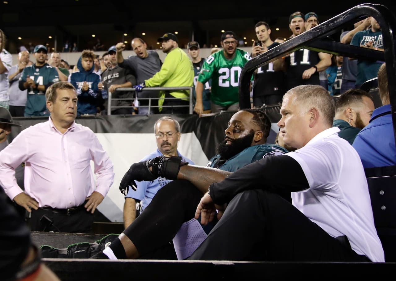 FILE - In this Monday, Oct. 23, 2017, file photo, fans cheer as Philadelphia Eagles offensive tackle Jason Peters, second from bottom right, is carted off the field during the second half of an NFL football game against the Washington Redskins in Philadelphia. Eagles coach Doug Pederson says Peters and starting linebacker Jordan Hicks will miss the rest of the season after being injured in Monday's 34-24 win over Washington. (AP Photo/Matt Rourke, File)