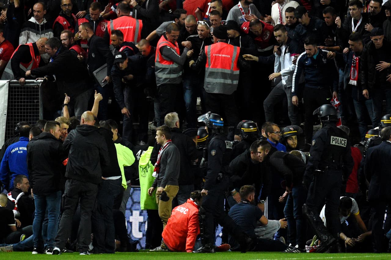 French police officers and members of the stadium staff gather to help LOSC's supporters following the fall of their tribune during the French L1 football match between Amiens and Lille LOSC on September 30, 2017 at the Licorne stadium in Amiens. / AFP PHOTO / FRANCOIS LO PRESTI (Photo credit should read FRANCOIS LO PRESTI/AFP/Getty Images)