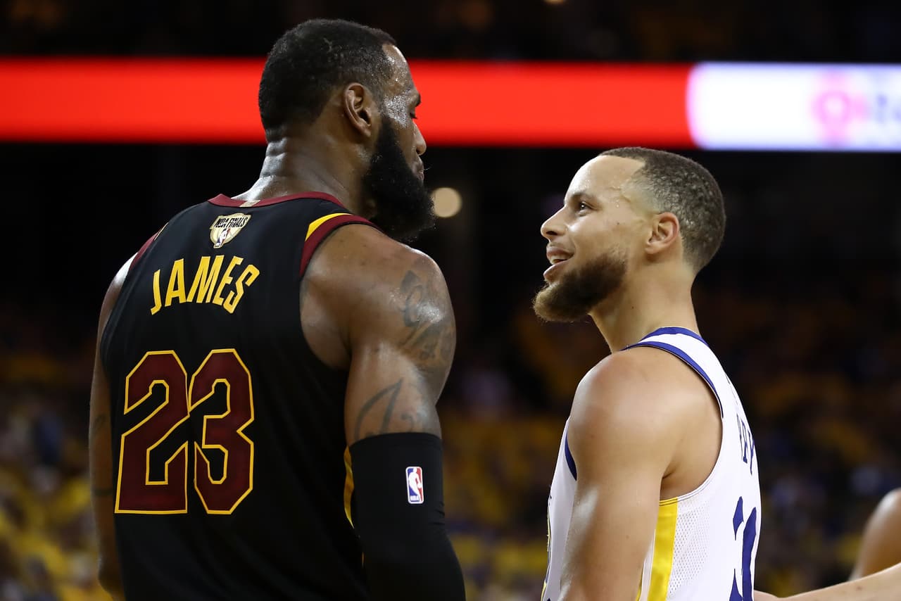 OAKLAND, CA - MAY 31: Stephen Curry #30 of the Golden State Warriors exchanges words with LeBron James #23 of the Cleveland Cavaliers in overtime during Game 1 of the 2018 NBA Finals at ORACLE Arena on May 31, 2018 in Oakland, California. NOTE TO USER: User expressly acknowledges and agrees that, by downloading and or using this photograph, User is consenting to the terms and conditions of the Getty Images License Agreement. (Photo by Ezra Shaw/Getty Images)