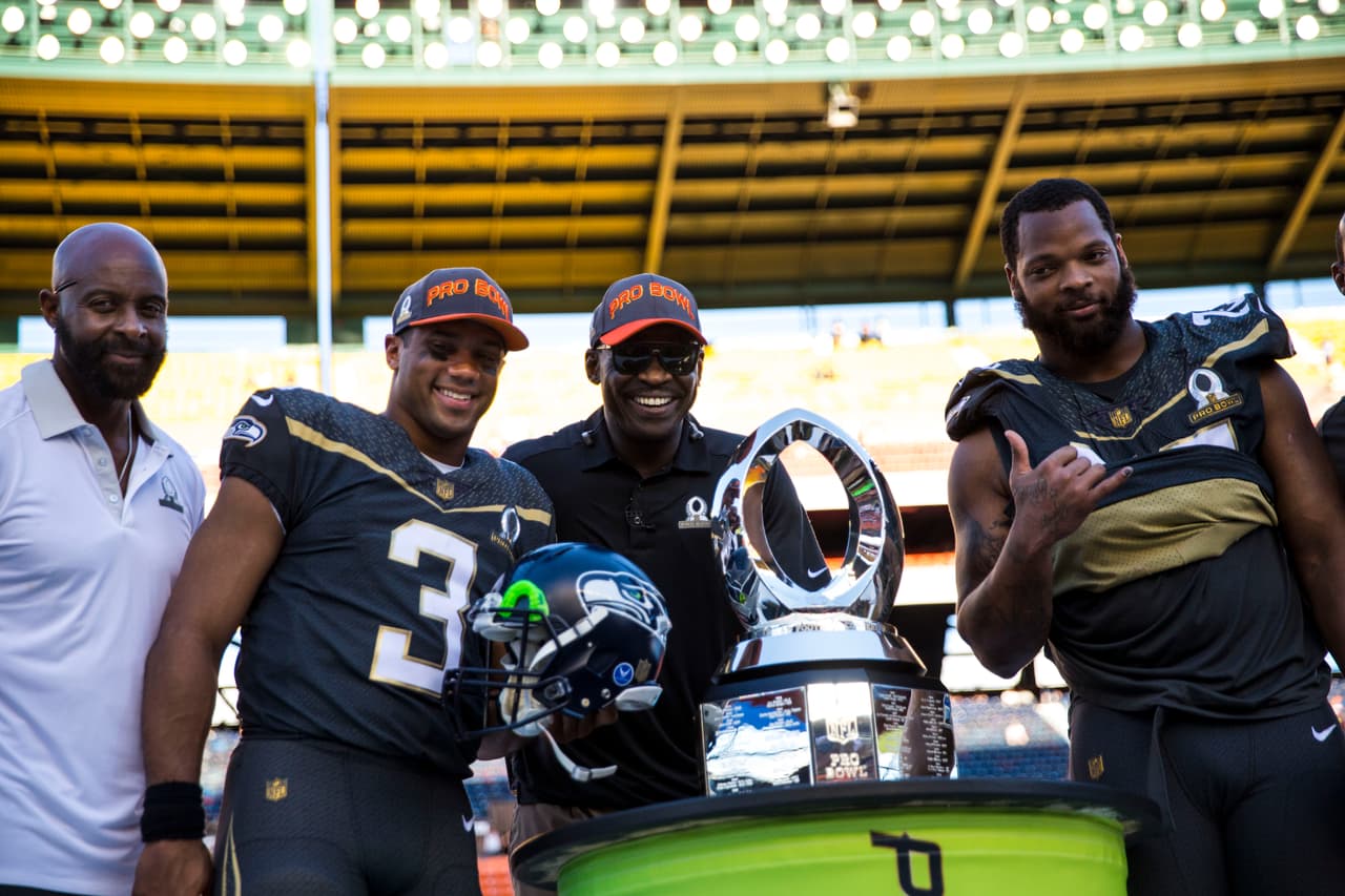 HONOLULU, HI - SUNDAY, JANUARY 31: Jerry Rice, Team Irvin quarterback Russell Wilson #3 of the Seattle Seahawks Michael Irvin, and defensive end Michael Bennett #72 of the Seattle Seahawks pose with the Pro Bowl Trophy after the end of the 2016 NFL Pro Bowl at Aloha Stadium on January 31, 2016 in Honolulu, Hawaii.Team Irvin defeated Team Rice 49-27. (Photo by Kent Nishimura/Getty Images)