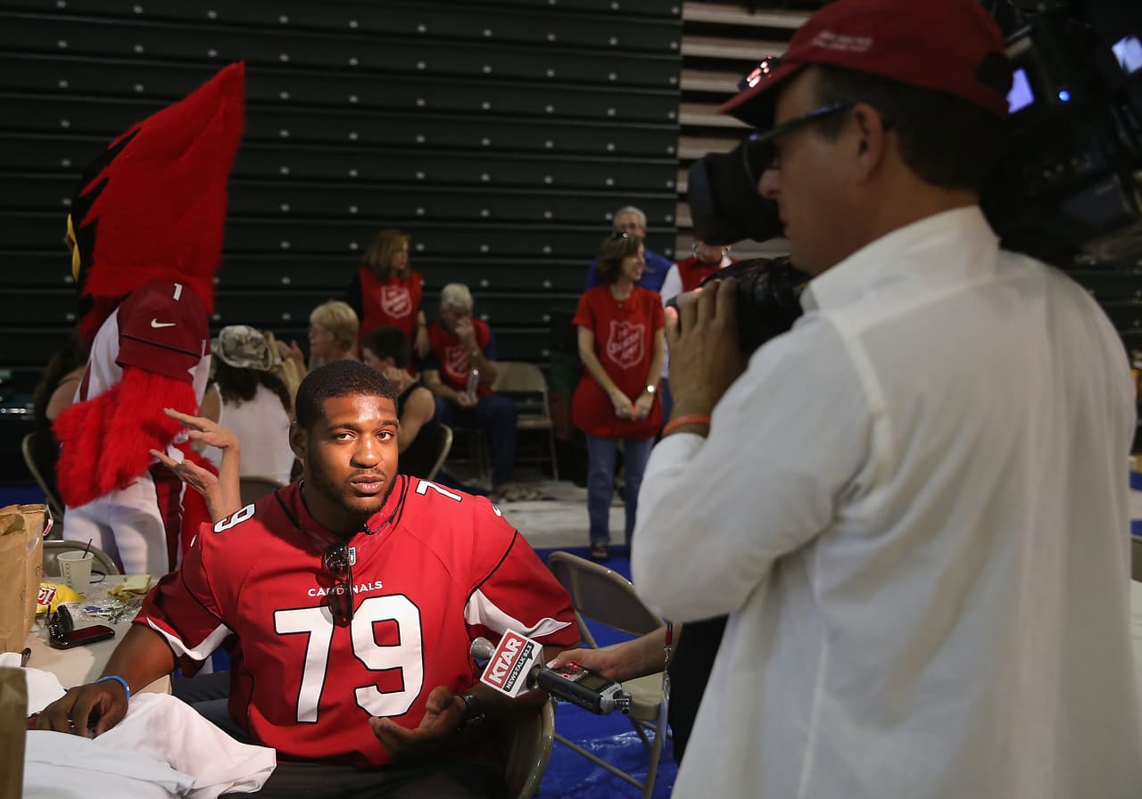 PRESCOTT, AZ - JULY 02: David Carter of the Arizona Cardinals speaks with the media as he visits the Red Cross shelter set up at the Yavapai College gymnasium for victims of the Yarnell Hill wildfires on July 2, 2013 in Prescott, Arizona. The Red Cross is providing families displaced by the fires in Yarnell, AZ food and shelter. Nineteen Granite Mountain Interagency Hotshot Crew firefighters died battling the fast-moving wildfire that has burned nearly 8,400 acres. (Photo by Christian Petersen/Getty Images)