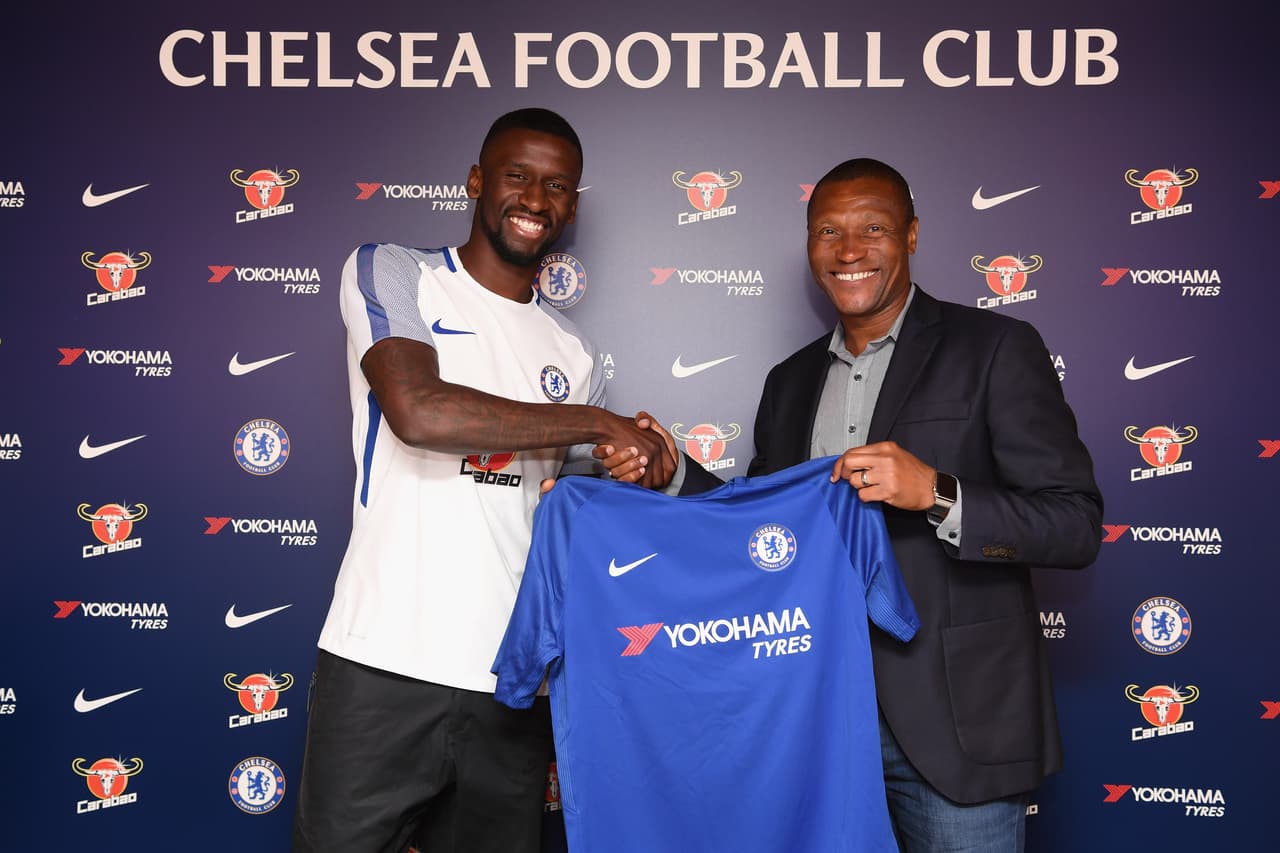 COBHAM, ENGLAND - JULY 09: Antonio Rudiger of Chelsea holds his shirt with Technical Director of Chelseaa Michael Emenalo after signing a 5 year contract at Chelsea Training Ground on July 9, 2017 in Cobham, England. (Photo by Darren Walsh/Chelsea FC via Getty Images)