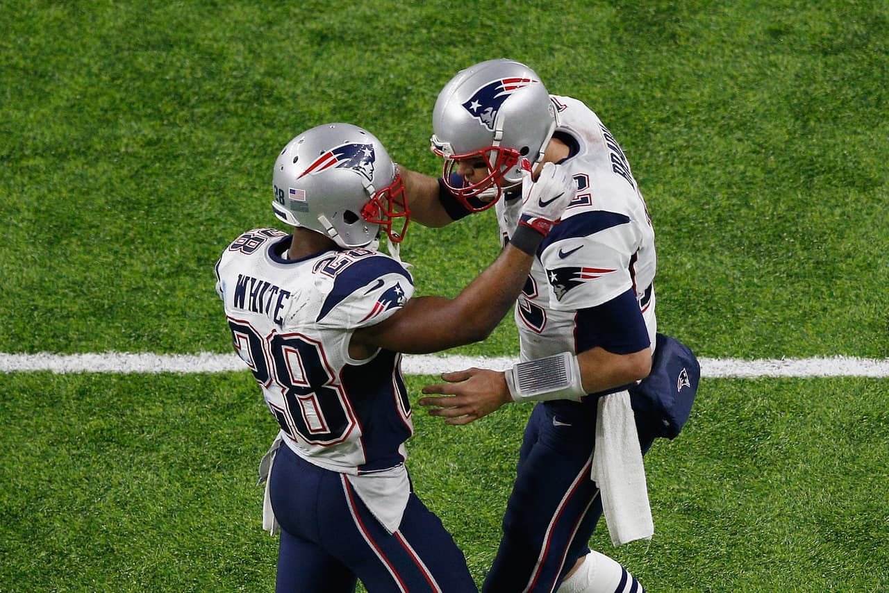 HOUSTON, TX - FEBRUARY 05: James White #28 celebrates with Tom Brady #12 of the New England Patriots after rushing for a 1-yard touchdown in the fourth quarter against the Atlanta Falcons during Super Bowl 51 at NRG Stadium on February 5, 2017 in Houston, Texas. (Photo by Bob Levey/Getty Images)