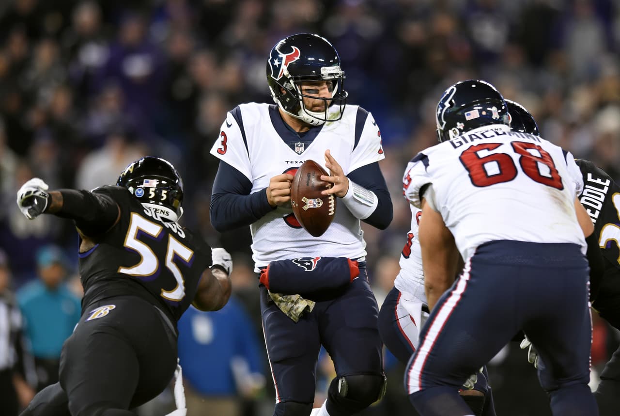 Houston Texans quarterback Tom Savage, center, tries to maintain possession as he is pressured by Baltimore Ravens outside linebacker Terrell Suggs (55) in the second half of an NFL football game, Monday, Nov. 27, 2017, in Baltimore. (AP Photo/Gail Burton)