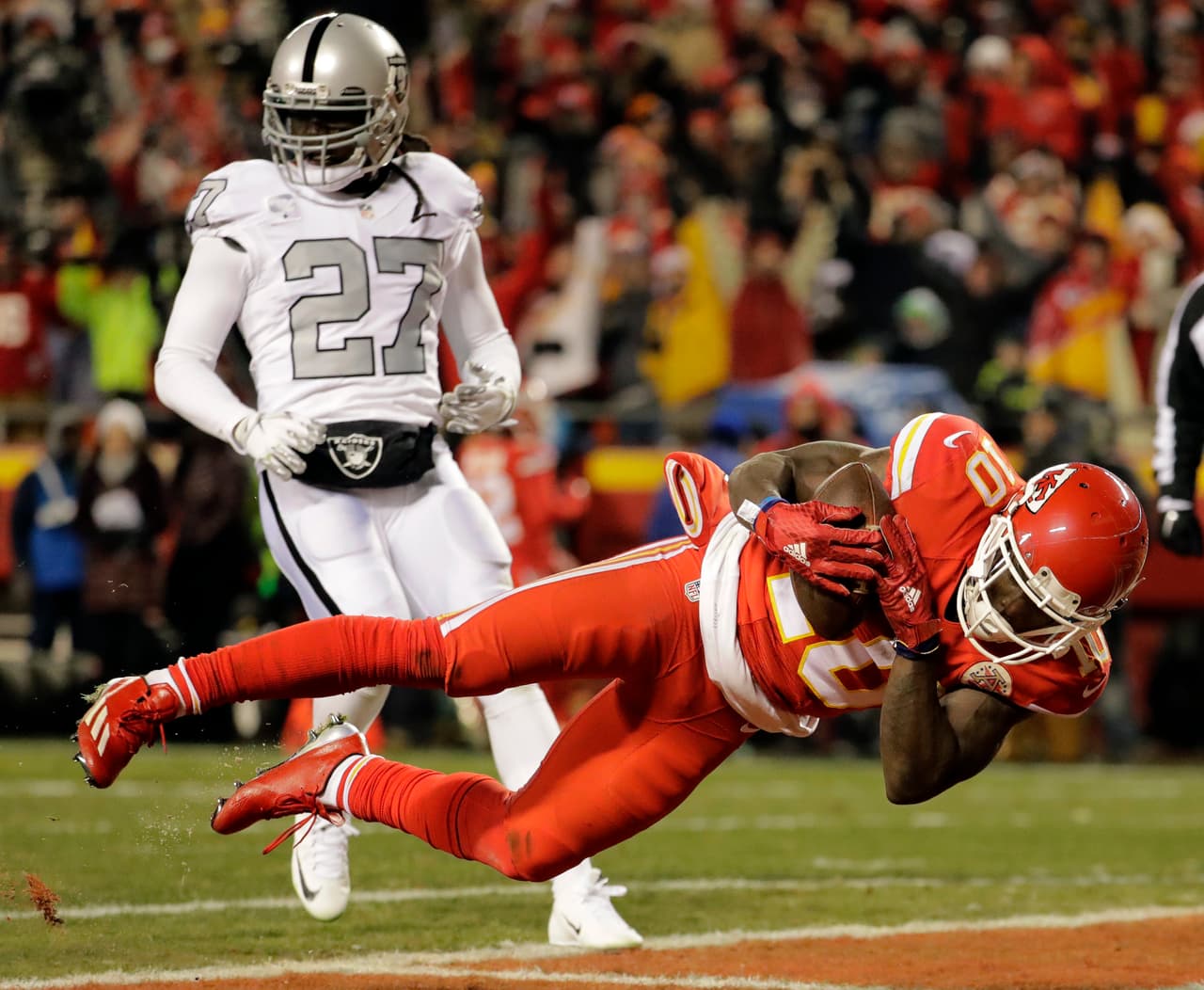 Oakland Raiders safety Reggie Nelson (27) watches as Kansas City Chiefs wide receiver Tyreek Hill (10) scores a touchdown during the first half of an NFL football game in Kansas City, Mo., Thursday, Dec. 8, 2016. (AP Photo/Charlie Riedel)