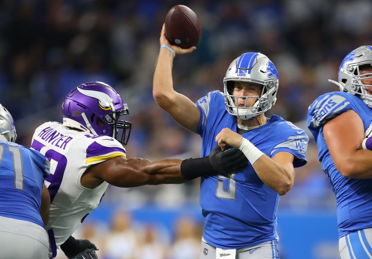 DETROIT, MICHIGAN - OCTOBER 20: Matthew Stafford #9 of the Detroit Lions tries to get a first half pass off around Danielle Hunter #99 of the Minnesota Vikings at Ford Field on October 20, 2019 in Detroit, Michigan. (Photo by Gregory Shamus/Getty Images)