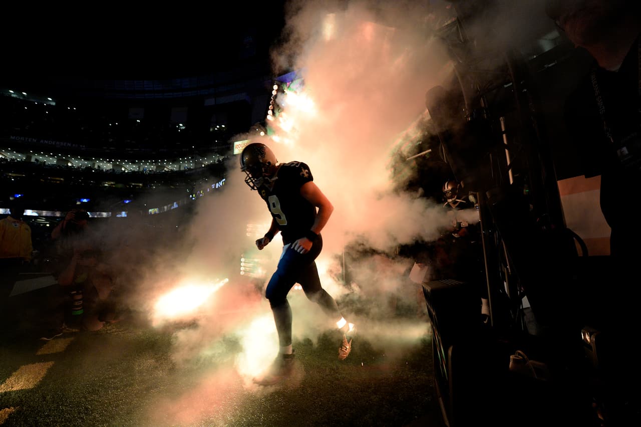 New Orleans Saints quarterback Drew Brees (9) enters the field the field for player introductions during pre-game festivities of an NFL football game against the Chicago Bears in New Orleans, Sunday, Oct. 29, 2017. The Saints won 20-12. (AP Photo/Bill Feig)