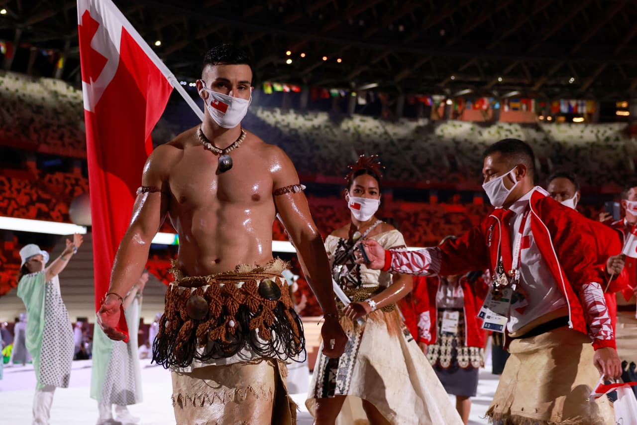 Tonga's flag bearers Pita Taufatofua (L) and Malia Paseka (2L) lead their delegation as they parade during the opening ceremony of the Tokyo 2020 Olympic Games, at the Olympic Stadium, in Tokyo, on July 23, 2021. (Photo by Odd ANDERSEN / AFP) (Photo by ODD ANDERSEN/AFP via Getty Images)