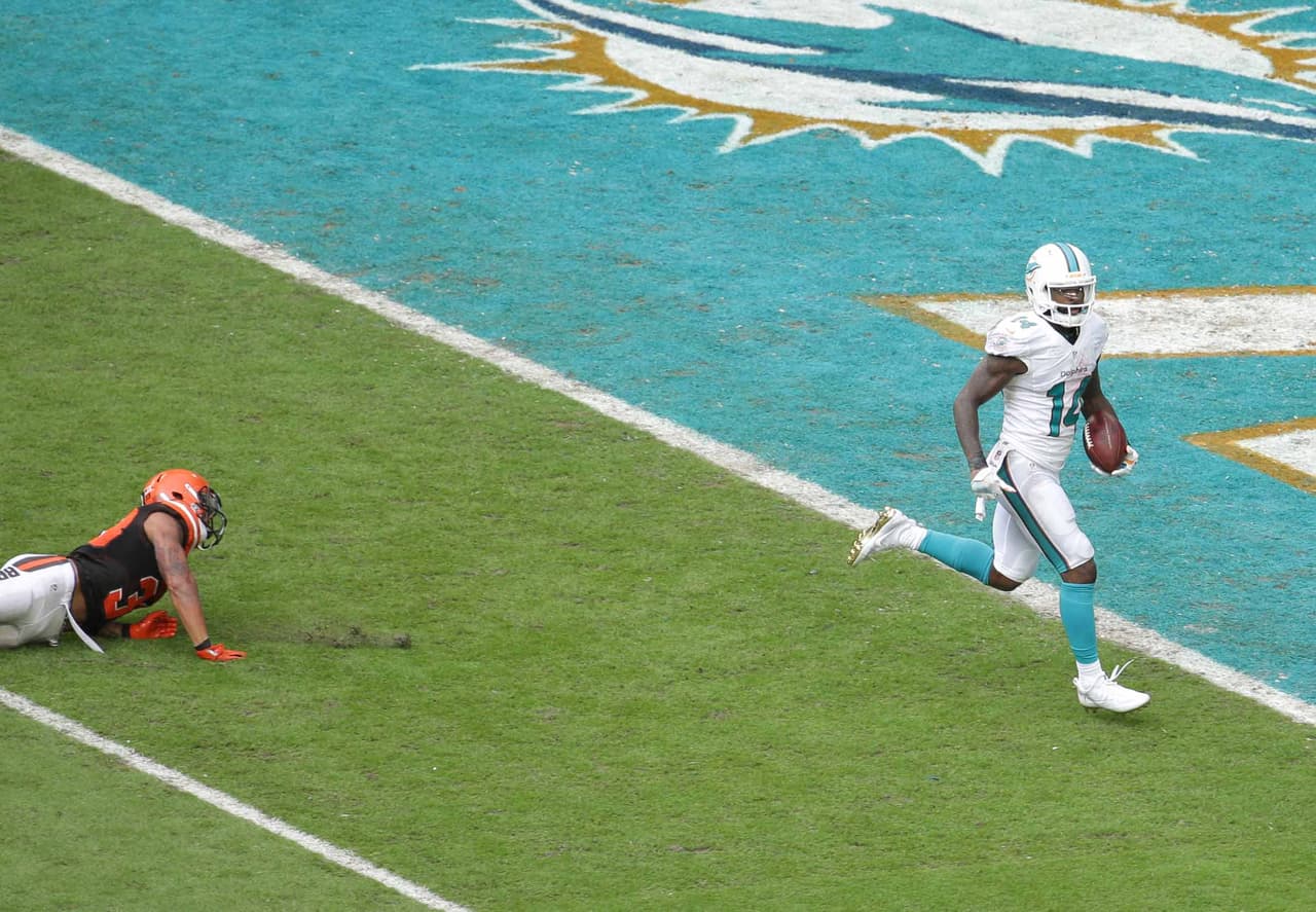 Miami Dolphins wide receiver Jarvis Landry (14) scores a touchdown as Cleveland Browns free safety Jordan Poyer (33) is unable to tackle, during the second half of an NFL football game, Sunday, Sept. 25, 2016, in Miami Gardens, Fla. (AP Photo/Lynne Sladky)