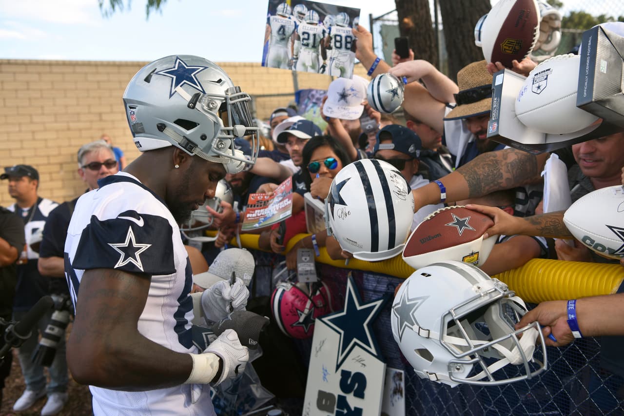 Dallas Cowboys wide receiver Dez Bryant gives autographs following practice at the NFL football team's training camp in Oxnard, Calif., Monday, July 24, 2017. (AP Photo/Michael Owen Baker)