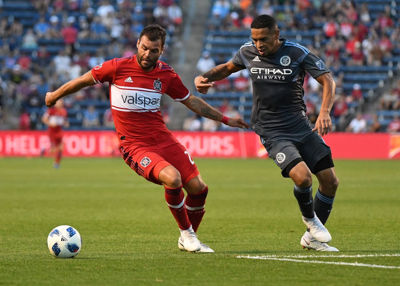 Jun 30, 2018; Chicago, IL, USA; Chicago Fire forward Nemanja Nikolic (23) kicks the ball past New York City defender Alexander Callens (6) during the second half at Bridgeview Stadium. Mandatory Credit: Mike DiNovo-USA TODAY Sports