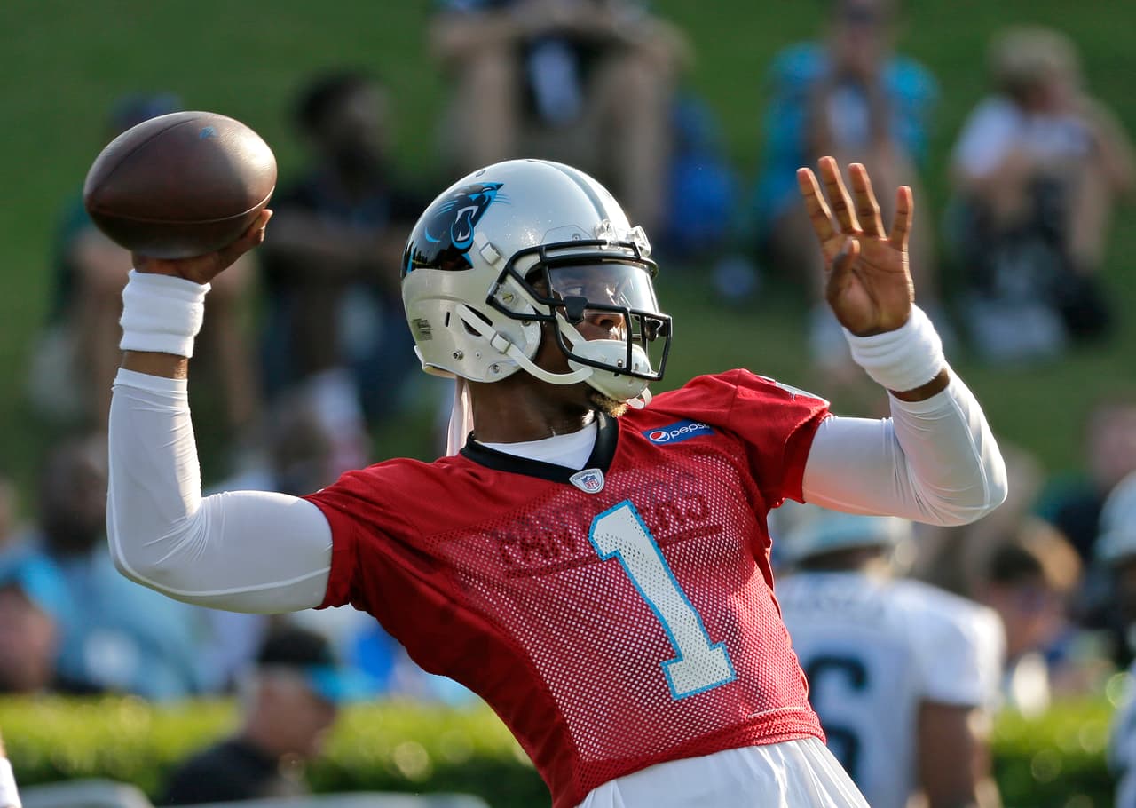 Carolina Panthers quarterback Cam Newton looks to throw a pass during practice at NFL football training camp at Wofford College in Spartanburg, S.C., Wednesday, July 26, 2017. (AP Photo/Chuck Burton)