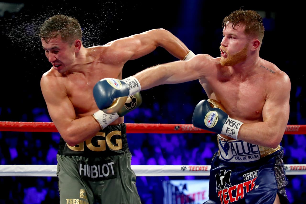LAS VEGAS, NV - SEPTEMBER 16: (R-L) Canelo Alvarez throws a punch at Gennady Golovkin during their WBC, WBA and IBF middleweight championionship bout at T-Mobile Arena on September 16, 2017 in Las Vegas, Nevada. (Photo by Al Bello/Getty Images)