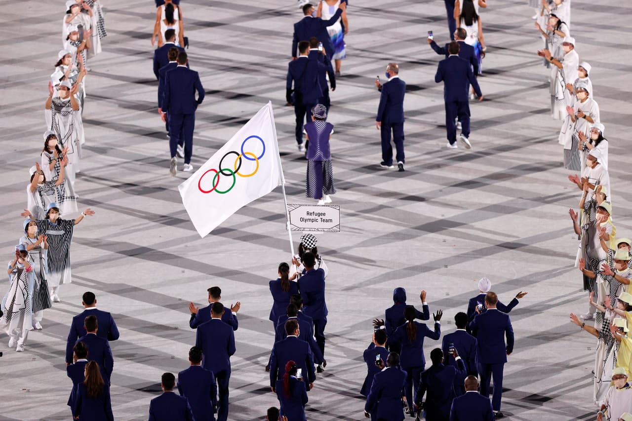 TOKYO, JAPAN - JULY 23: Flag bearers Yusra Mardini and Tachlowini Gabriyesos of the Refugee Olympic Team lead their team out during the Opening Ceremony of the Tokyo 2020 Olympic Games at Olympic Stadium on July 23, 2021 in Tokyo, Japan. (Photo by Ezra Shaw/Getty Images)