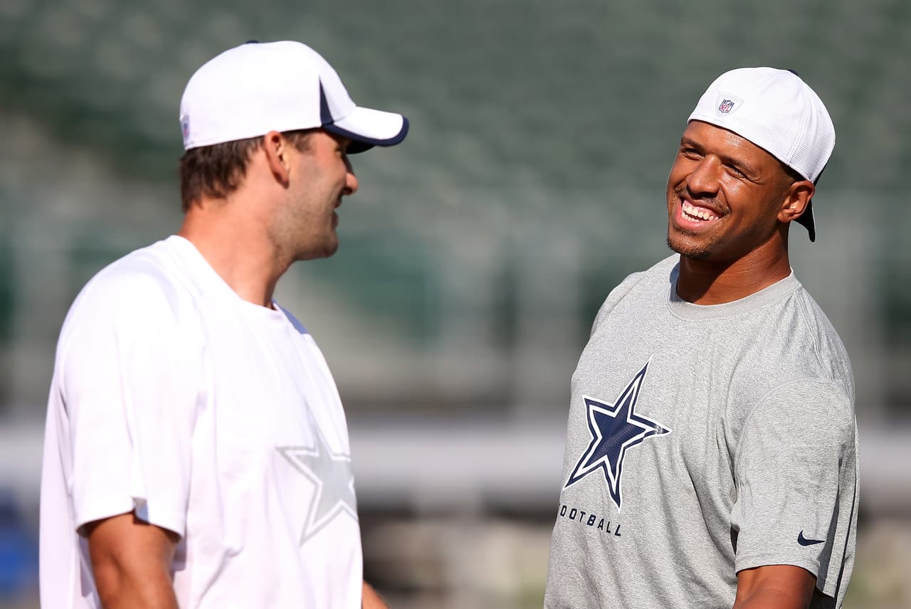 Dallas Cowboys wide receiver Miles Austin (19) shares a laugh with Dallas Cowboys quarterback Tony Romo (9) while warming up before the NFL preseason week 1 football game against the Oakland Raiders on Friday, Aug. 9, 2013 in Oakland, Calif. The Raiders won the game 19-17. (AP Photo/Paul Spinelli)