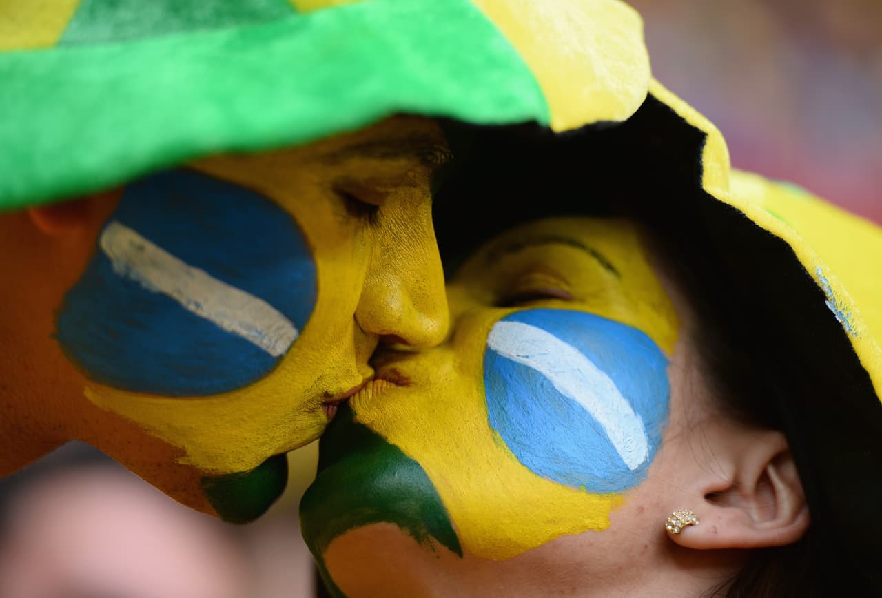 BRASILIA, BRAZIL - JULY 12: Brazil fans kiss prior to the 2014 FIFA World Cup Brazil Third Place Playoff match between Brazil and the Netherlands at Estadio Nacional on July 12, 2014 in Brasilia, Brazil. (Photo by Jamie McDonald/Getty Images)