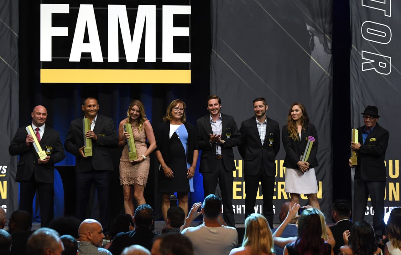 LAS VEGAS, NV - JULY 05: (L-R) Former mixed martial artists Matt Serra and Dan Henderson, family members of the late UFC producer Bruce Connal, Carly Connal, Karen Connal, Trevor Connal and Tyler Connal, Ronda Rousey and UFC creator and co-founder Art Davie pose onstage at the end of the UFC Hall of Fame's class of 2018 induction ceremony at The Pearl concert theater at Palms Casino Resort on July 5, 2018 in Las Vegas, Nevada. (Photo by Ethan Miller/Getty Images)