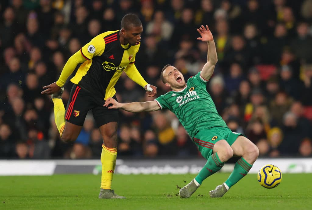 WATFORD, ENGLAND - JANUARY 01: Christian Kabasele of Watford fouls Diogo Jota of Wolverhampton Wanderers resulting in a red card during the Premier League match between Watford FC and Wolverhampton Wanderers at Vicarage Road on January 01, 2020 in Watford, United Kingdom. (Photo by Catherine Ivill/Getty Images)