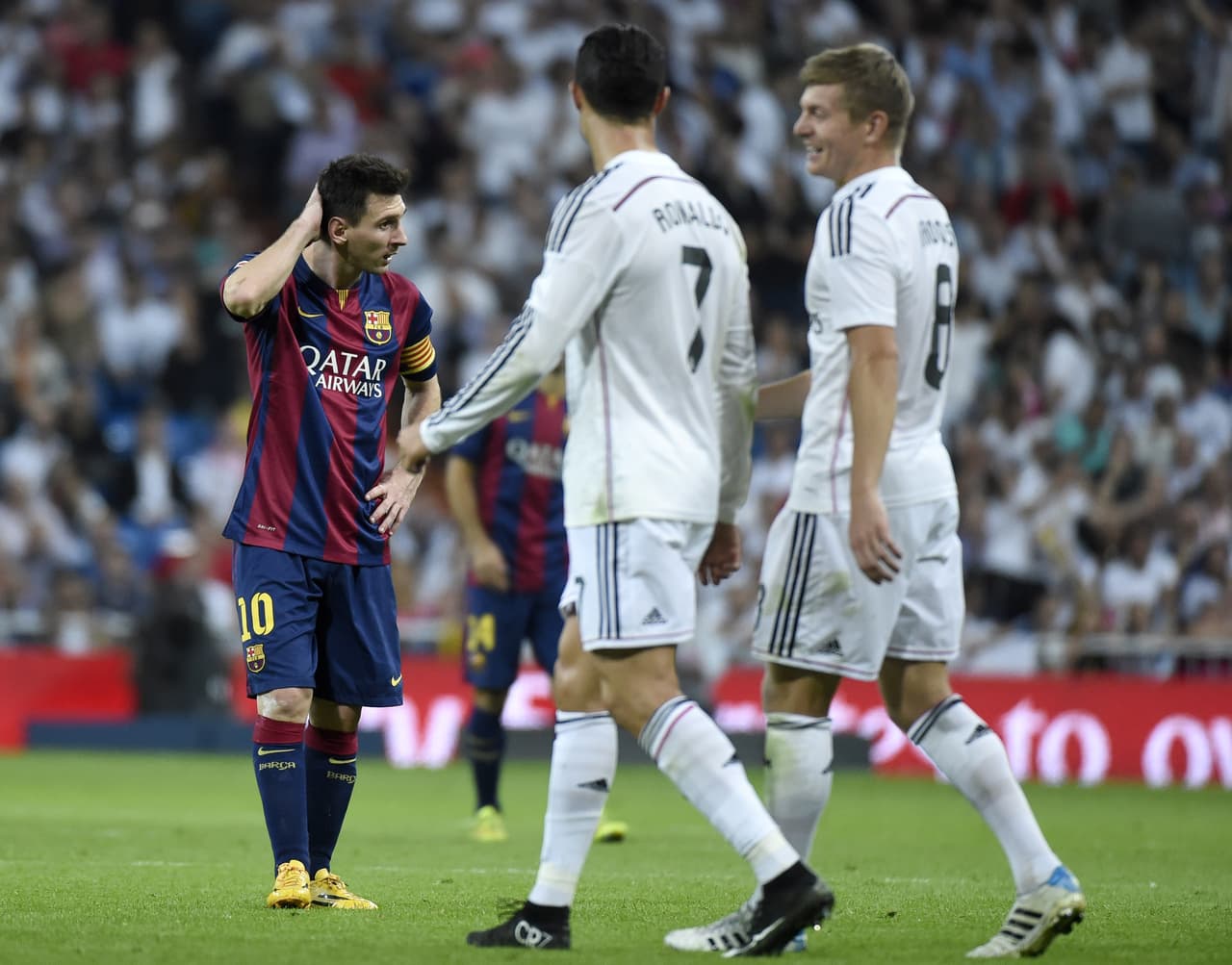 Barcelona's Argentinian forward Lionel Messi (L) looks on next to Real Madrid's Portuguese forward Cristiano Ronaldo (C) and Real Madrid's German midfielder Toni Kroos (R) during the Spanish league "Clasico" football match Real Madrid CF vs FC Barcelona at the Santiago Bernabeu stadium in Madrid on October 25, 2014. Real Madrid won the match 3-1. AFP PHOTO / GERARD JULIEN (Photo credit should read GERARD JULIEN/AFP/Getty Images)