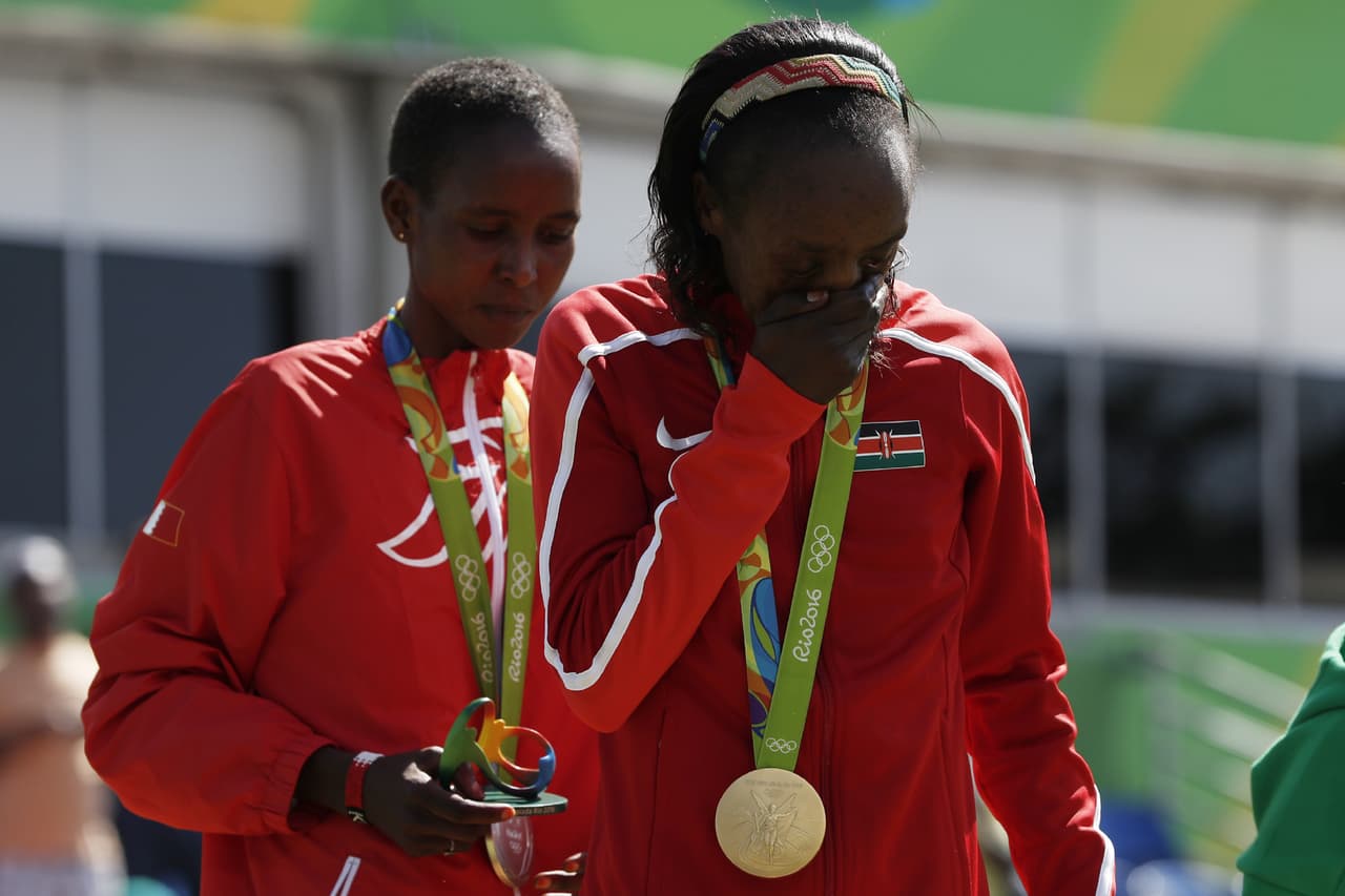 Gold medalist Kenya's Jemima Jelagat (C) Sumgong reacts after the podium ceremony for the Women's Marathon during the athletics event at the Rio 2016 Olympic Games at Sambodromo in Rio de Janeiro on August 14, 2016. / AFP / Adrian DENNIS (Photo credit should read ADRIAN DENNIS/AFP/Getty Images)