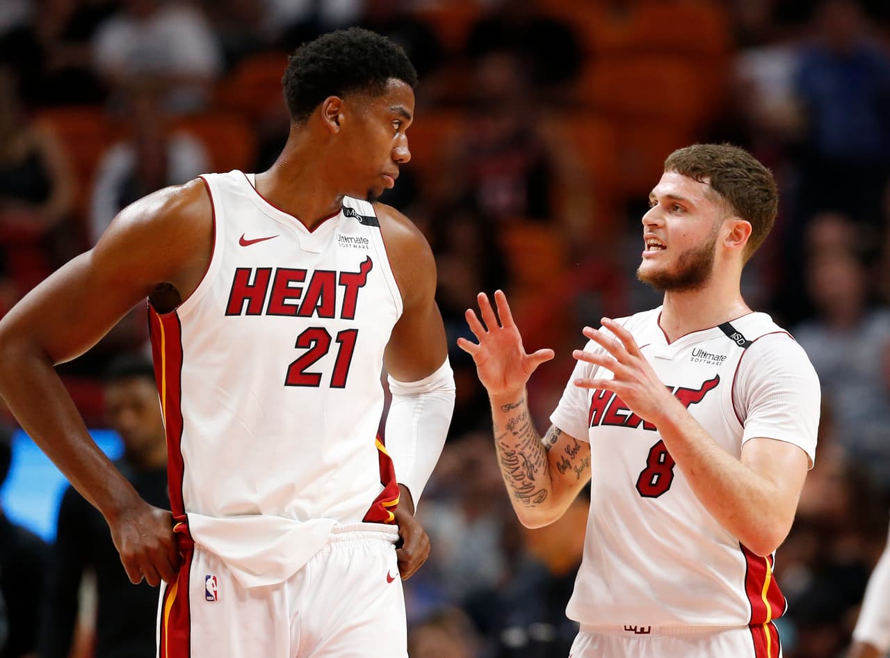 Miami Heat center Hassan Whiteside (21) and guard Tyler Johnson (8) talk during the first half of an NBA basketball game against the Atlanta Hawks, Tuesday, April 3, 2018, in Miami. (AP Photo/Wilfredo Lee)