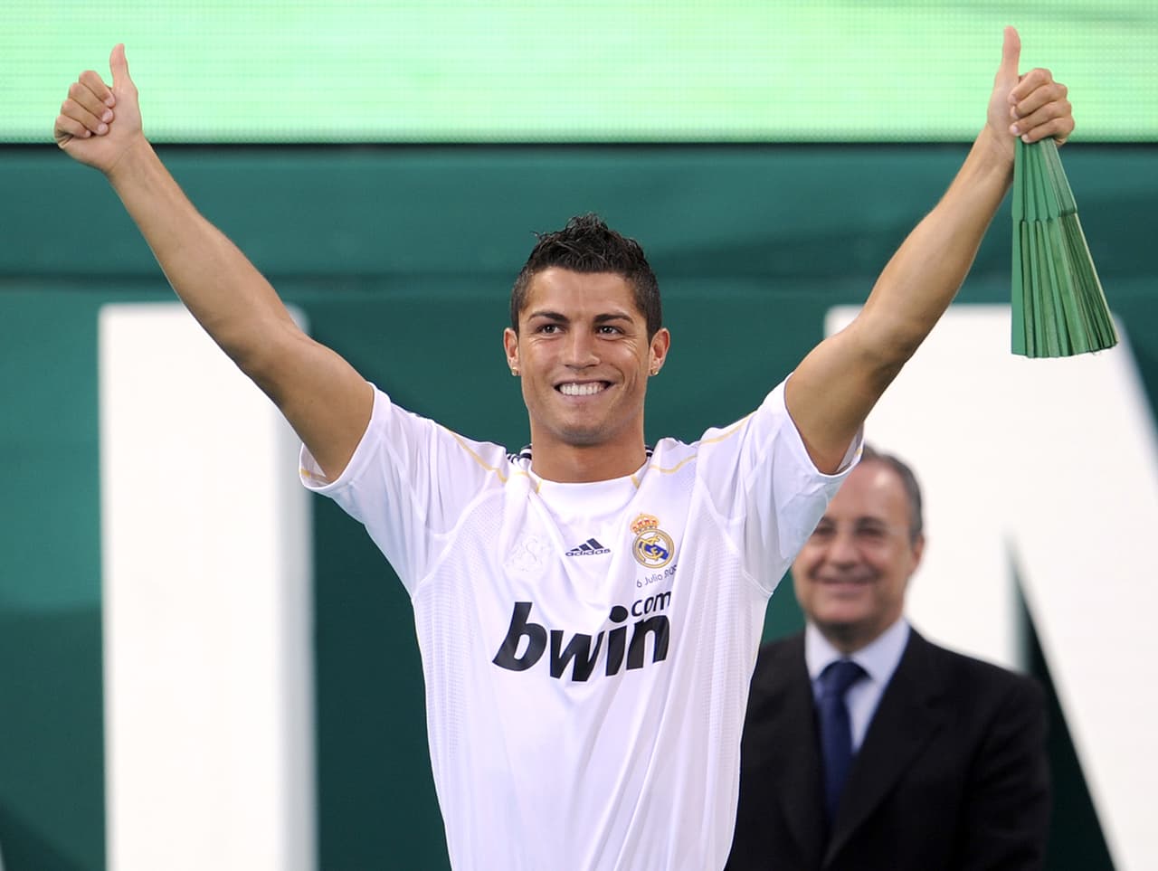 Real Madrid's new player Portuguese Cristiano Ronaldo waves to supporters during his official presentation at the Santiago Bernabeu stadium in Madrid on July 6, 2009. Real acquired the 24-year-old Portuguese striker from Manchester United last month on a six-year deal worth 94 million euros (131 million dollars) and Spanish media reports that he will be paid 13 million euros each season. AFP PHOTO / PIERRE-PHILIPPE MARCOU (Photo credit should read PIERRE-PHILIPPE MARCOU/AFP/Getty Images)