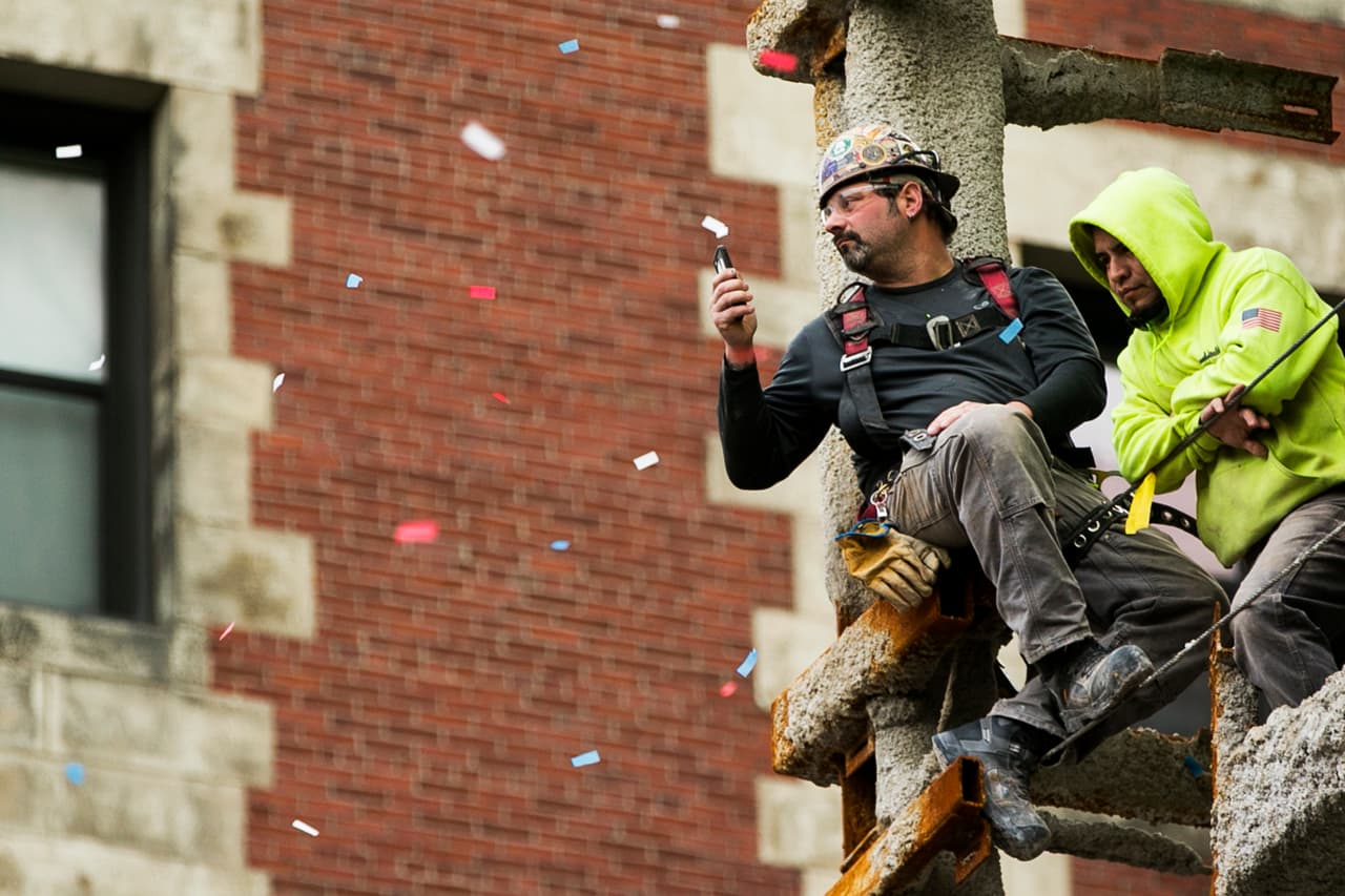 BOSTON, MA - OCTOBER 31: Construction workers watch from a building during the 2018 World Series victory parade on October 31, 2018 in Boston, Massachusetts. (Photo by Adam Glanzman/Getty Images)