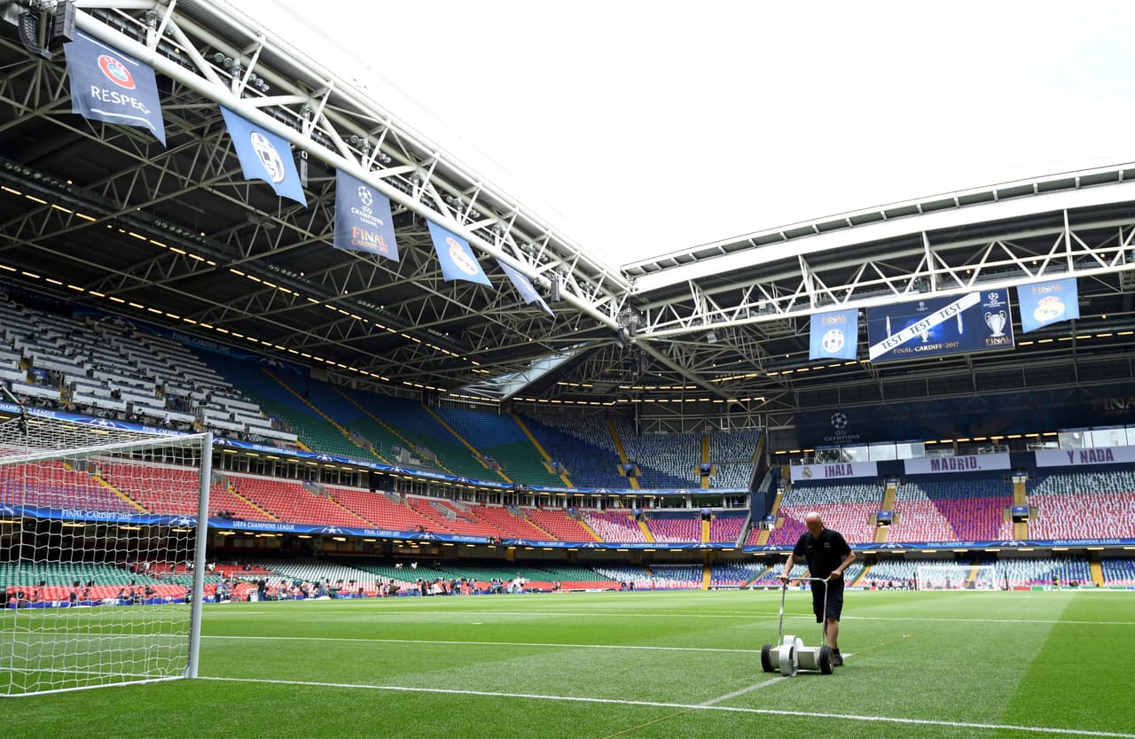 A groundsman puts the finishing touches to the pitch ahead of the UEFA Champions League final football match between Juventus and Real Madrid at The Principality Stadium in Cardiff, south Wales, on June 3, 2017. / AFP PHOTO / Glyn KIRK (Photo credit should read GLYN KIRK/AFP/Getty Images)