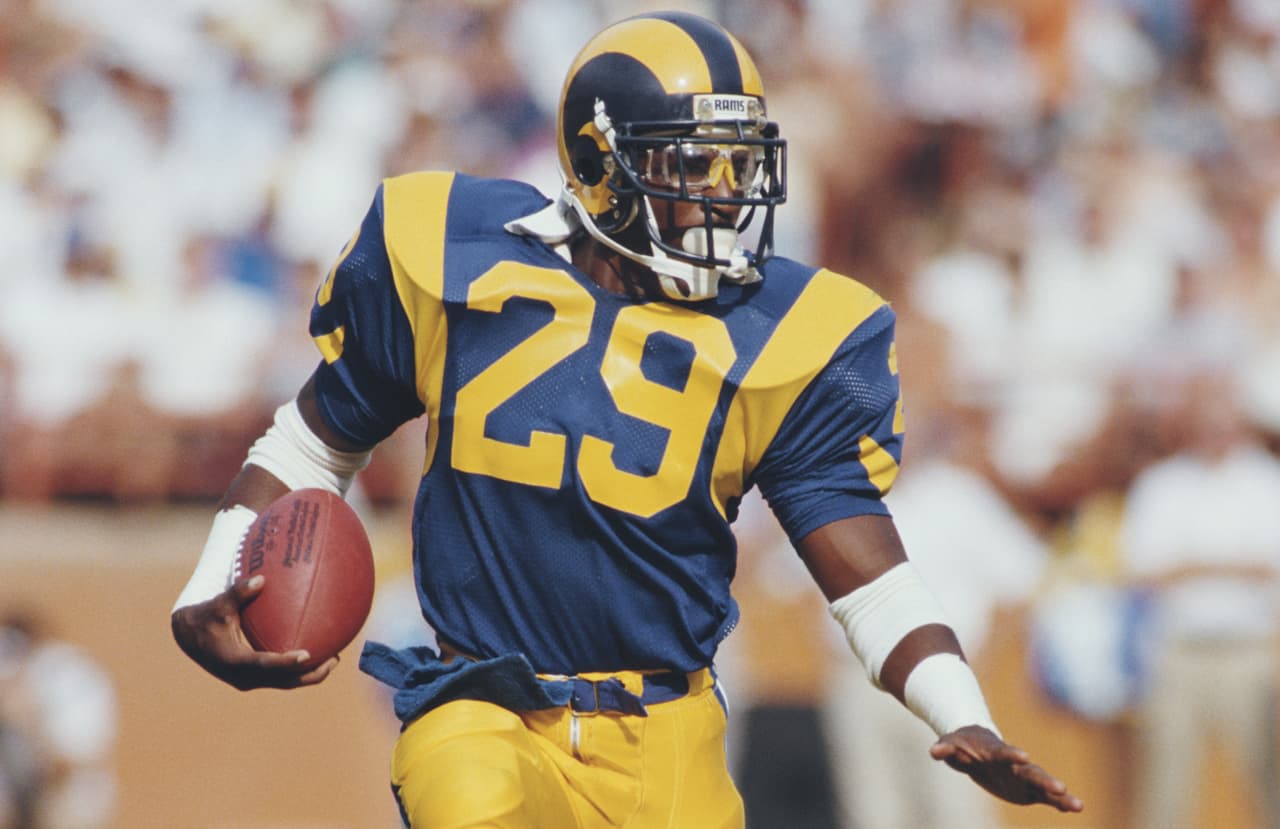 Eric Dickerson #29, Running back for the Los Angeles Rams runs the ball during the National Football Conference West game against the Detroit Lions on 19 October 1986 at the Anaheim Stadium, Anaheim, California, United States. The Rams won the game 14 - 10. (Photo by Rick Stewart/Allsport/Getty Images)