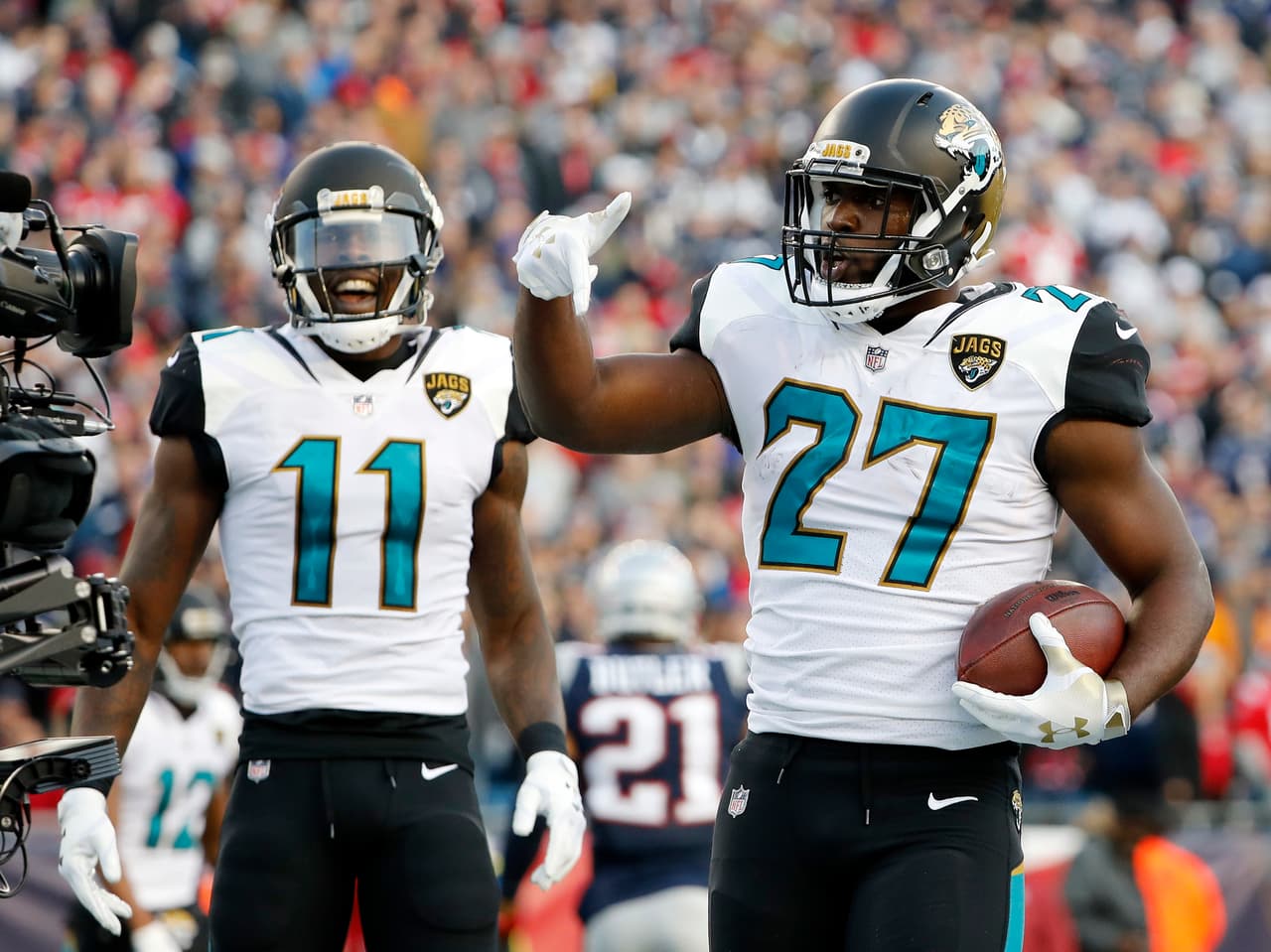 Jacksonville Jaguars running back Leonard Fournette (27) celebrates a touchdown with wide receiver Marqise Lee (11) during the first half of the AFC championship NFL football game against the New England Patriots, Sunday, Jan. 21, 2018, in Foxborough, Mass. (AP Photo/Winslow Townson)