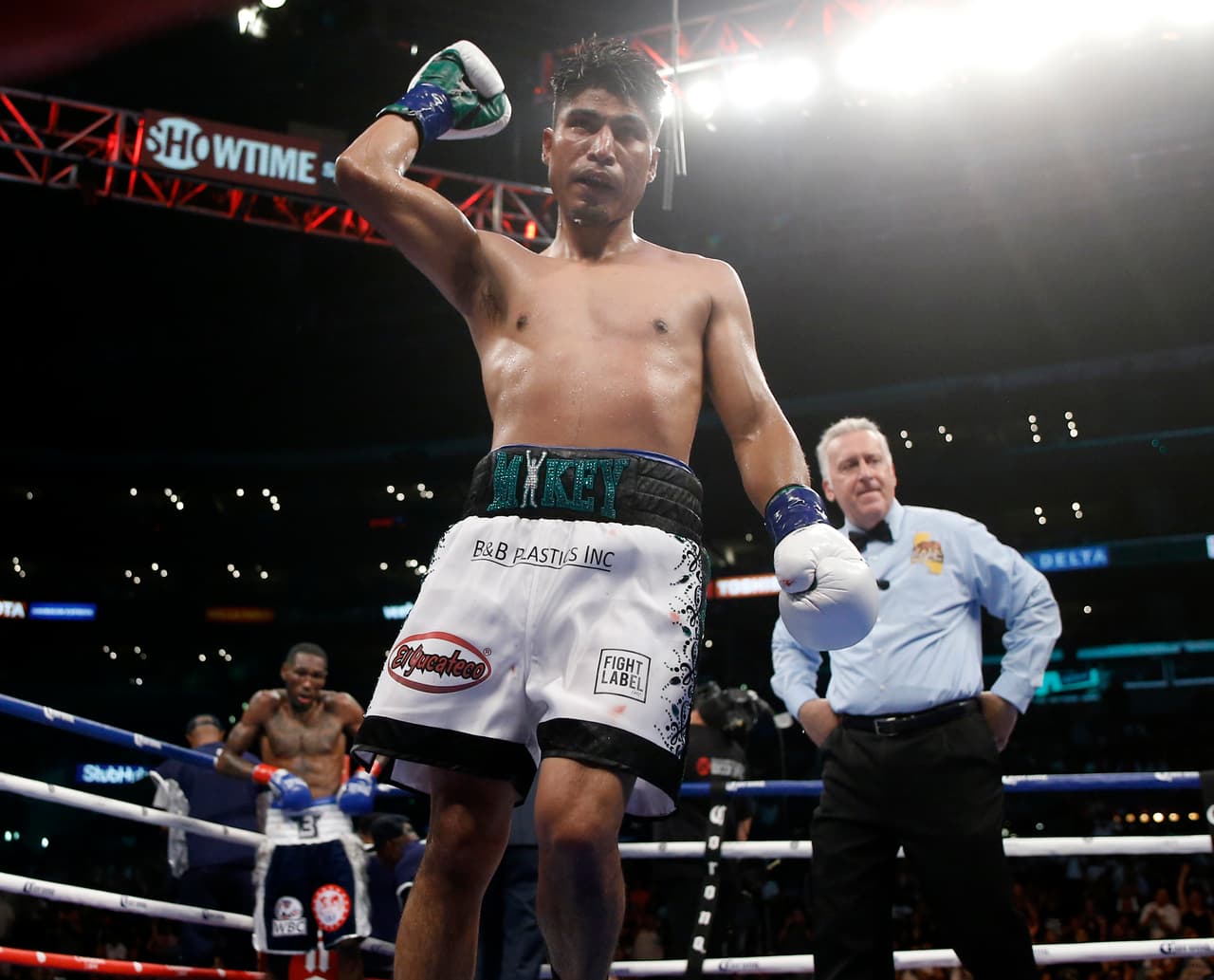 Mikey Garcia, center, raises his arm after the 11th round against Robert Easter Jr., left, during their WBC and IBF world lightweight title bout in Los Angeles, Saturday, July 28, 2018. At right is Judge Jack Reiss. Garcia won by unanimous decision. (AP Photo/Alex Gallardo)