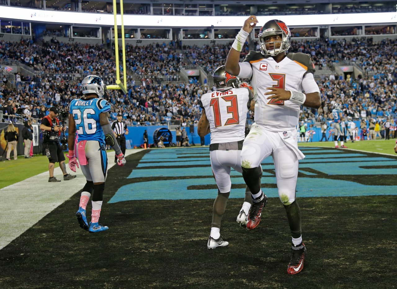 Tampa Bay Buccaneers' Jameis Winston (3) and Mike Evans (13) celebrate their touchdown as Carolina Panthers' Daryl Worley (26) walks away in the second half of an NFL football game in Charlotte, N.C., Monday, Oct. 10, 2016. (AP Photo/Bob Leverone)