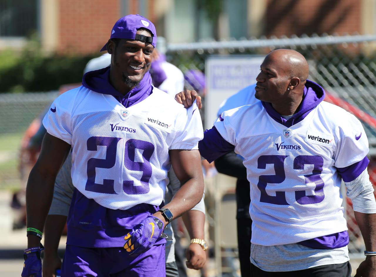 Minnesota Vikings cornerbacks Xavier Rhodes (29) and Terrence Newman (23) share a laugh walking to practice during NFL football training camp Thursday, July 27, 2017, in Mankato, Minn. (AP Photo/Andy Clayton-King)