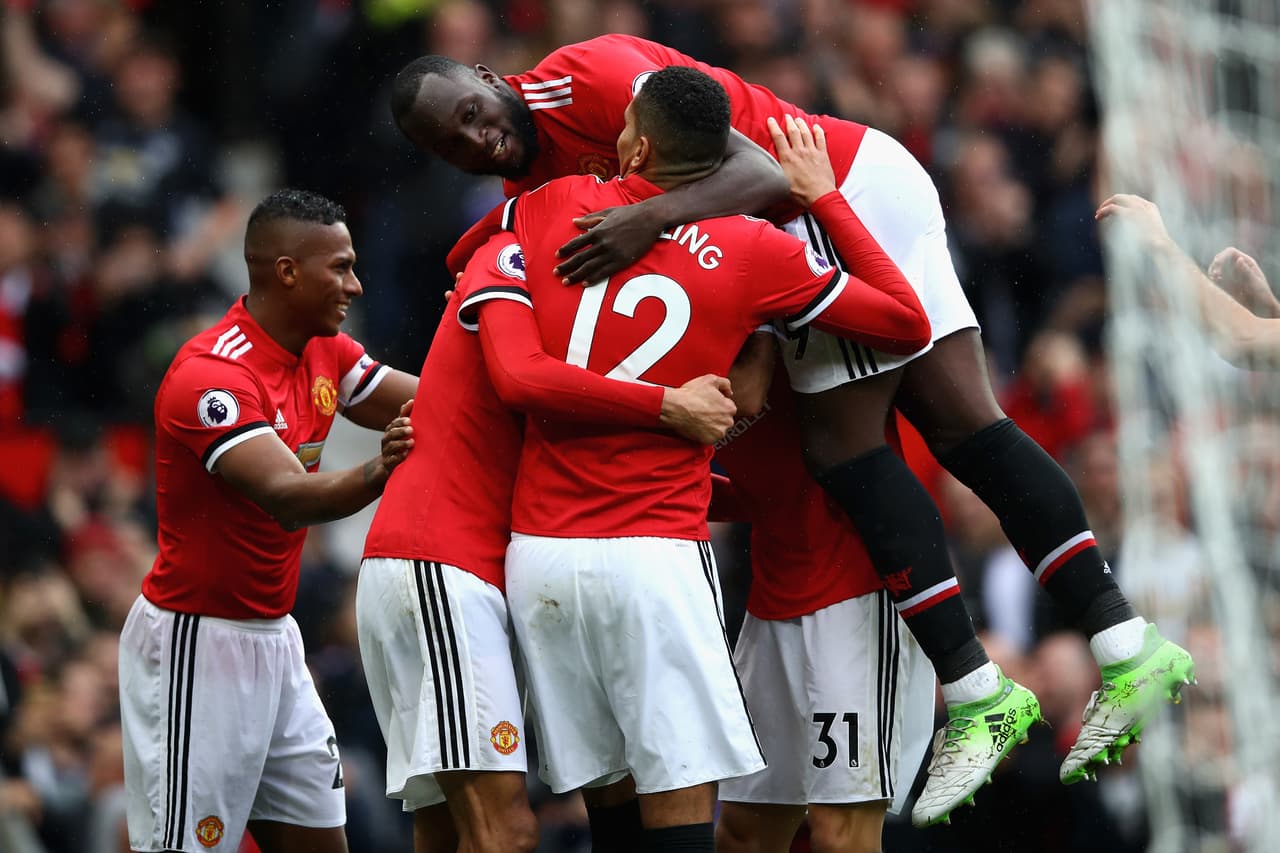MANCHESTER, ENGLAND - SEPTEMBER 30: Romelu Lukaku (top) of Manchester United joins the celebration as Marouane Fellaini (2nd L) of Manchester United scroing his side's third goal during the Premier League match between Manchester United and Crystal Palace at Old Trafford on September 30, 2017 in Manchester, England. (Photo by Clive Brunskill/Getty Images)