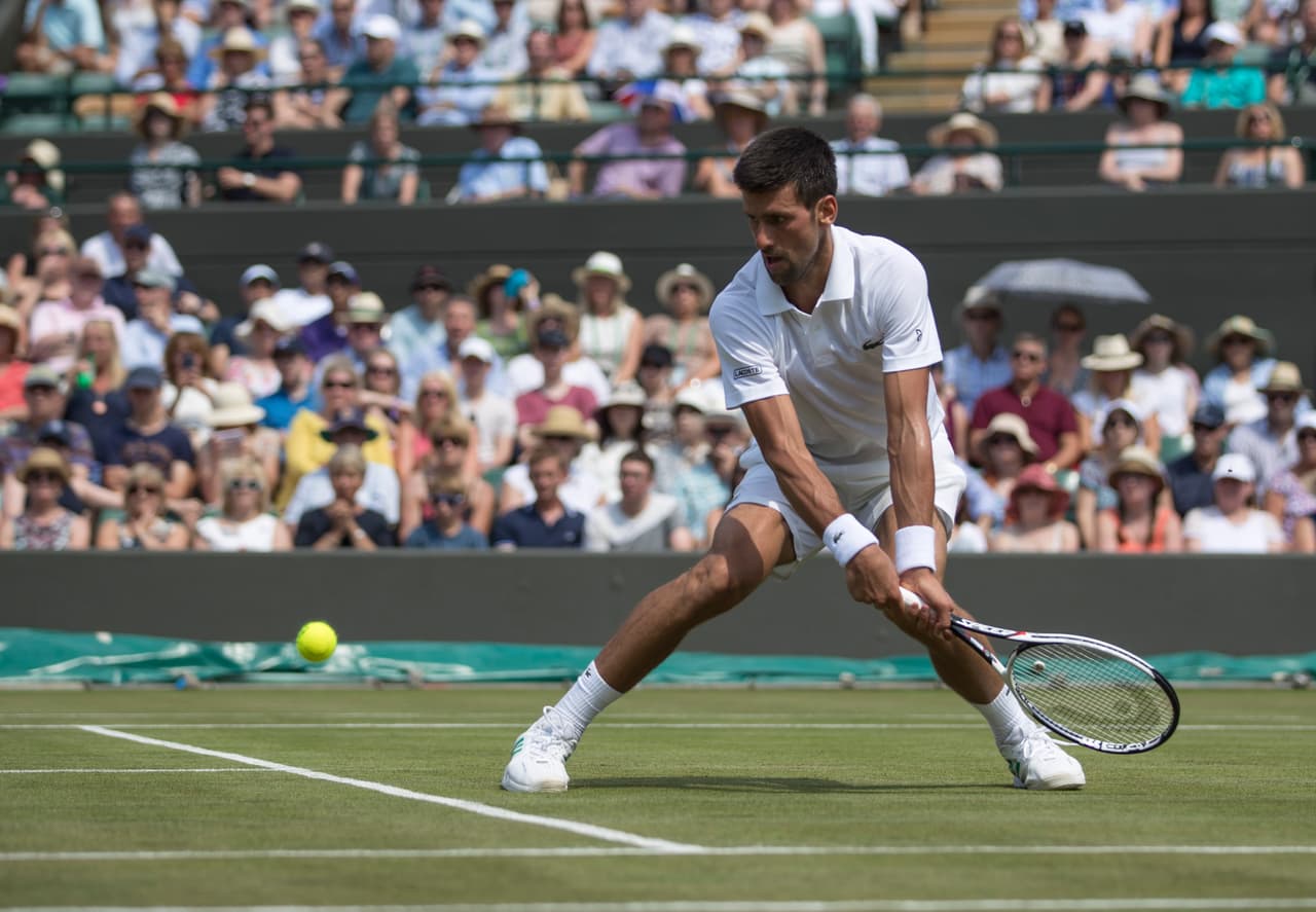 July 6th 2017, All England Lawn Tennis and Croquet Club, London, England; The Wimbledon Tennis Championships, Day 4; Novak Djokovic (SRB) hits a low backhand return to Adam Pavlasek (CZE) (Photo by Roland Harrison/Action Plus via Getty Images)