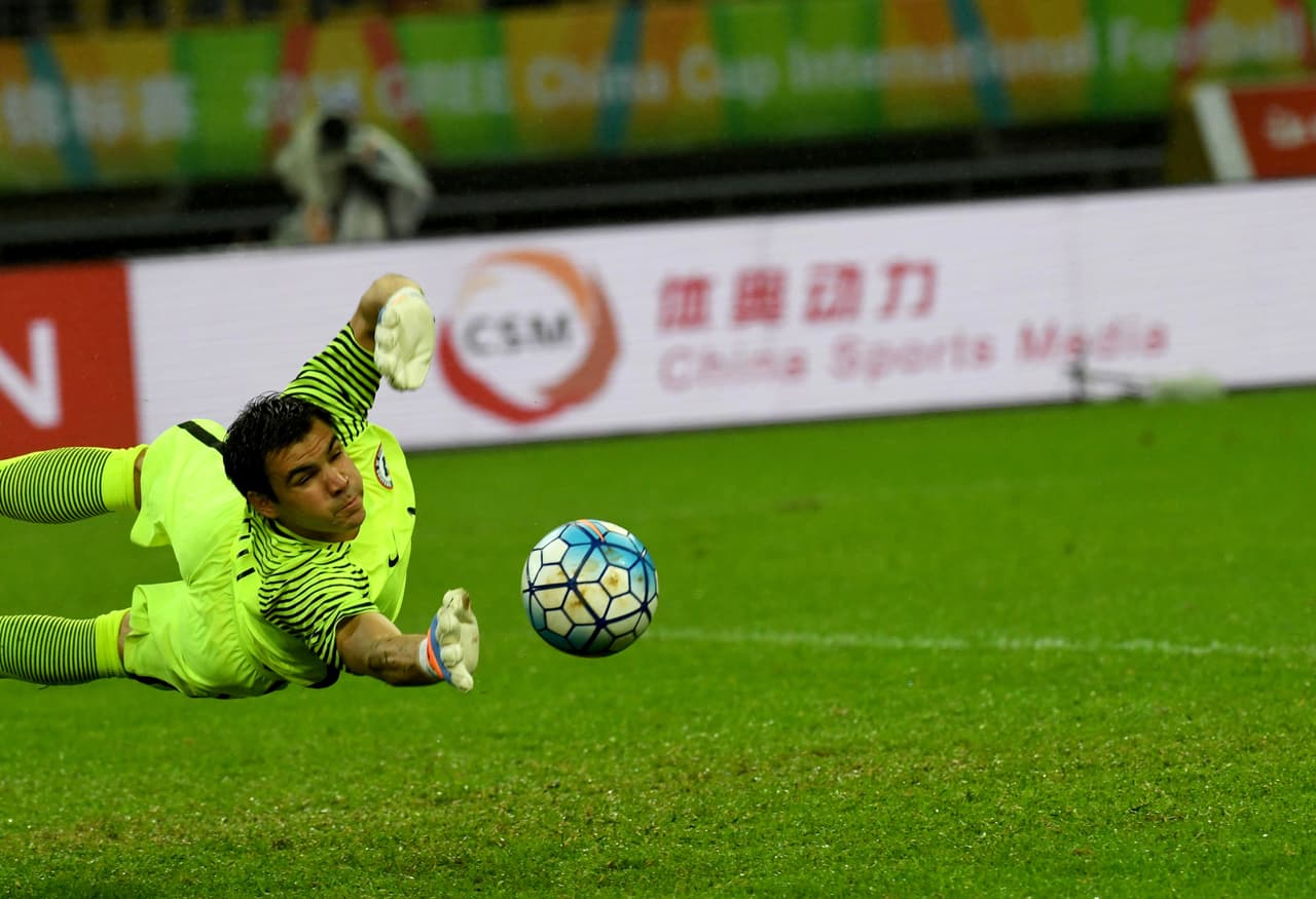 Chile's goalkeeper Cristopher Toselli tries to stop a penalty kick during a 2017 Gree China Cup International Football Championship group match against Croatia at Guangxi Sports Center Stadium in Nanning, south China's Guangxi province on January 11, 2017. / AFP / STR / CHINA OUT (Photo credit should read STR/AFP/Getty Images)