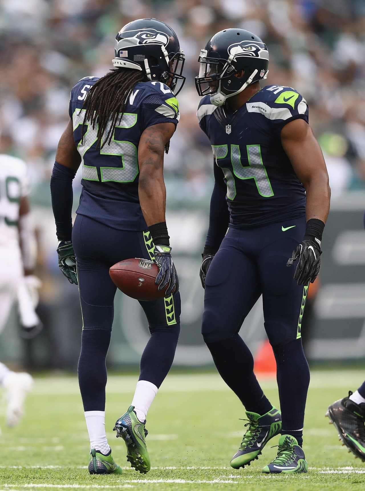 EAST RUTHERFORD, NJ - OCTOBER 02: Richard Sherman #25 of the Seattle Seahawks celebrates his interception in the first half with teammte Bobby Wagner #54 against the New York Jets at MetLife Stadium on October 2, 2016 in East Rutherford, New Jersey. (Photo by Elsa/Getty Images)