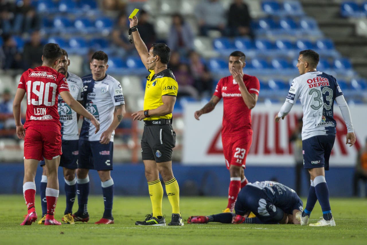 Giovanny Leon recibe un tarjeta amarilla tras fuerte entrada sobre el jugador del Pachuca.