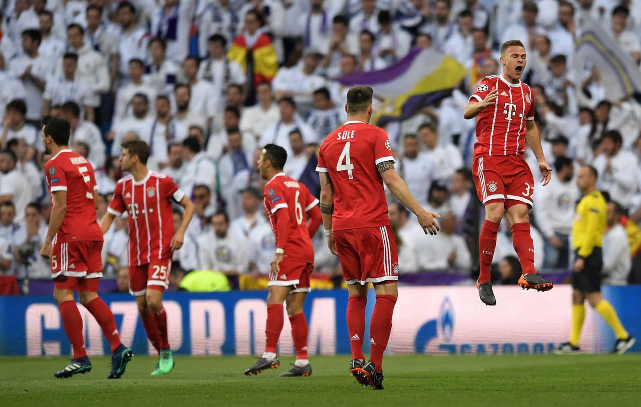 Bayern Munich's German midfielder Joshua Kimmich (R) celebrates after scoring the 0-1 during the UEFA Champions League semi-final second-leg football match Real Madrid CF vs FC Bayern Munich in Madrid, Spain, on May 1, 2018. (Photo by GABRIEL BOUYS / AFP) (Photo credit should read GABRIEL BOUYS/AFP/Getty Images)