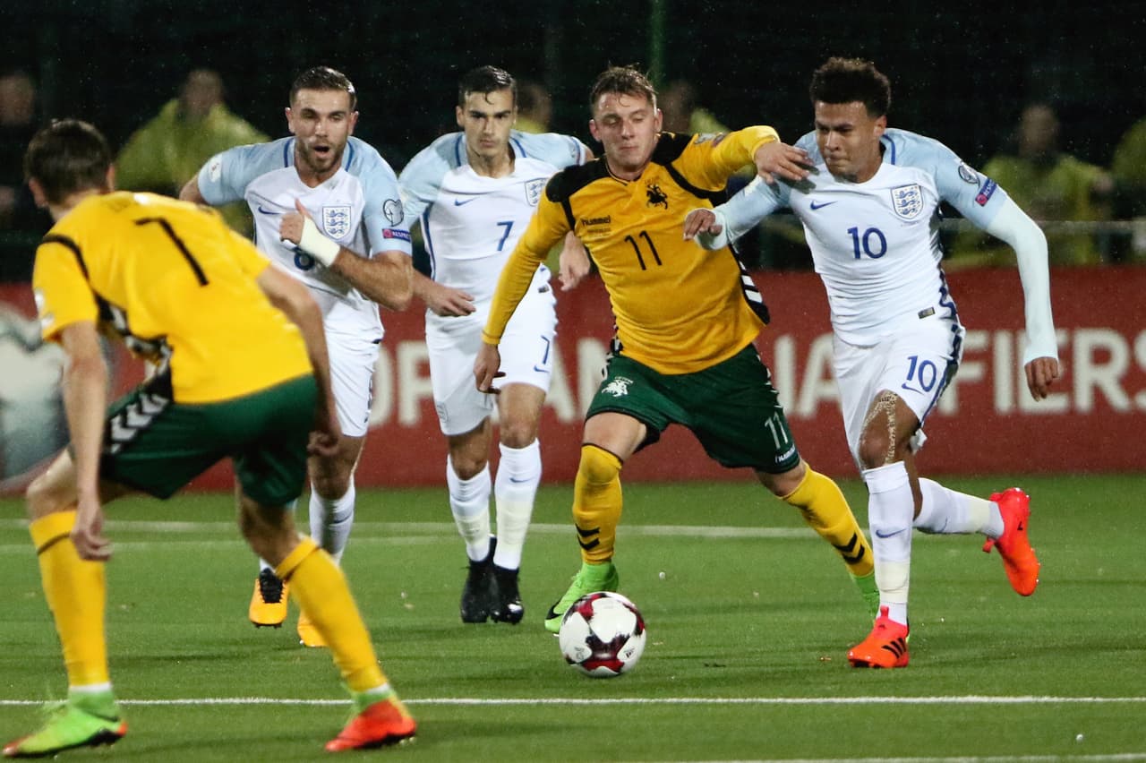 Lithuania's Arvydas Novikovas vies with England's midfielder Dele Alli (R) during the FIFA World Cup 2018 qualification football match between Lithuania and England in Vilnius on October 8, 2017. / AFP PHOTO / Petras Malukas (Photo credit should read PETRAS MALUKAS/AFP/Getty Images)