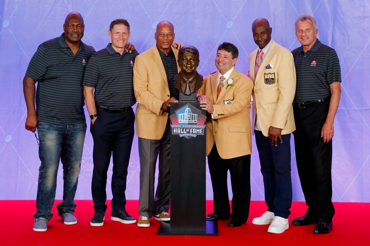 Pro Football Hall of Fame class of 2016 inductee former owner of the San Francisco 49ers Edward J. Bartolo Jr, third from right, is joined by a group of 49er Pro Football Hall of Famers from left; Charles Haley, Steve Young, Ronnie Lott, Jerry Rice and Joe Montana during an induction ceremony at the Pro Football Hall of Fame Saturday, Aug. 6, 2016, in Canton, Ohio. (AP Photo/Gene J. Puskar)
