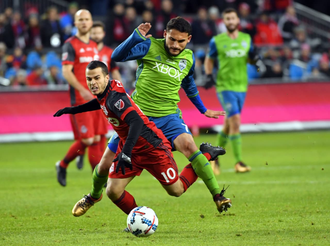 Dec 9, 2017; Toronto, Ontario, Canada; Toronto FC forward Sebastian Giovinco (10) goes down against Seattle Sounders midfielder Cristian Roldan (7) during the first half during the MLS Cup championship game at BMO Field. Mandatory Credit: Nick Turchiaro-USA TODAY Sports