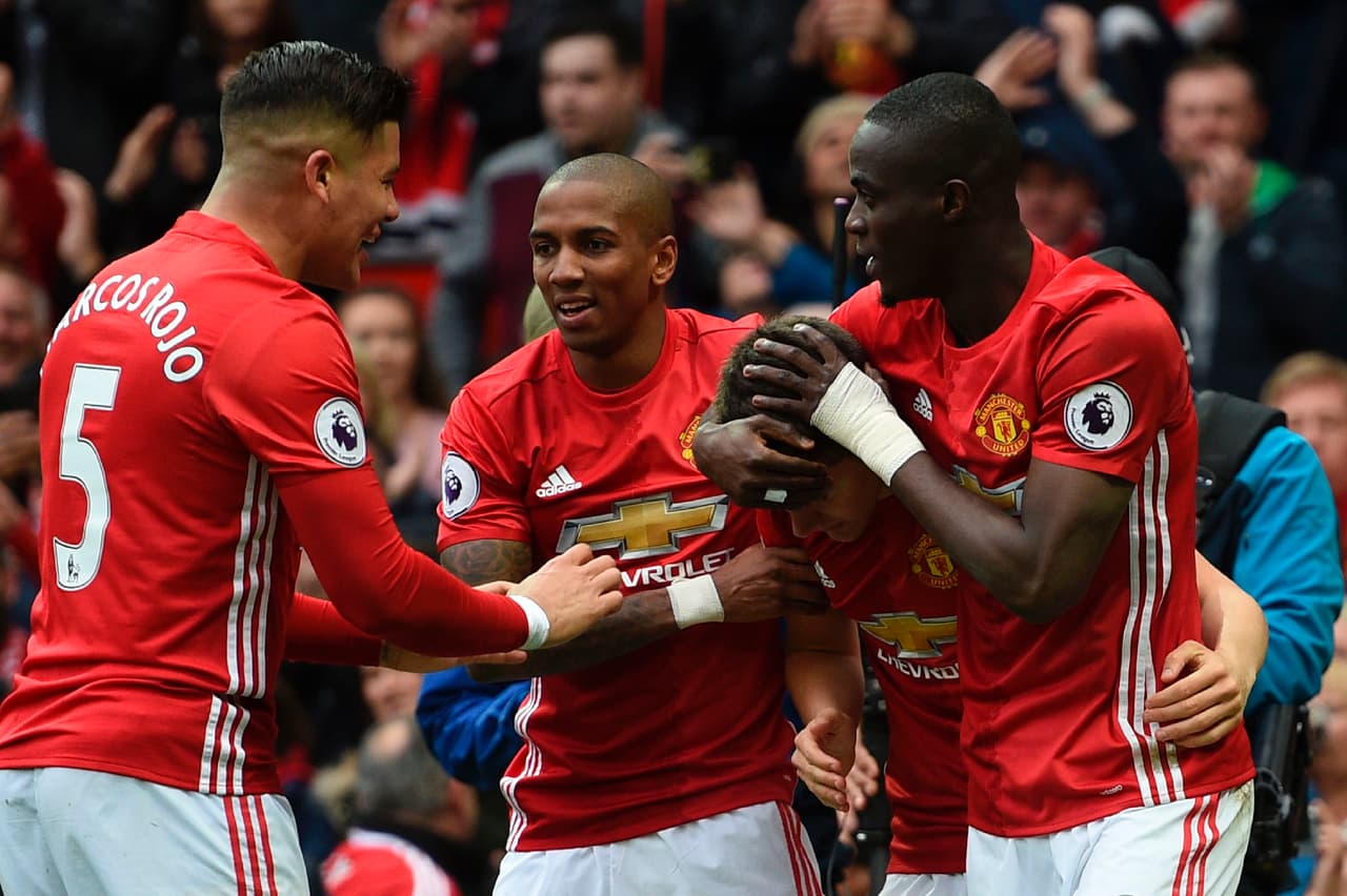 Manchester United's Spanish midfielder Ander Herrera (2R) celebrates scoring the second goal with teammates during the English Premier League football match between Manchester United and Chelsea at Old Trafford in Manchester, north west England, on April 16, 2017. / AFP PHOTO / Oli SCARFF / RESTRICTED TO EDITORIAL USE. No use with unauthorized audio, video, data, fixture lists, club/league logos or 'live' services. Online in-match use limited to 75 images, no video emulation. No use in betting, games or single club/league/player publications. / (Photo credit should read OLI SCARFF/AFP/Getty Images)