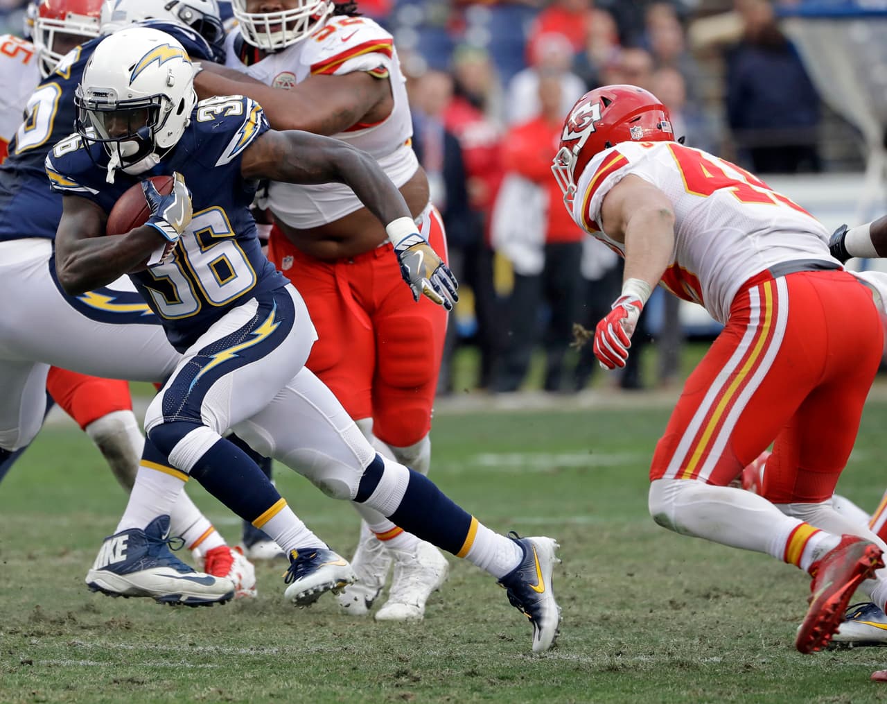 San Diego Chargers running back Ronnie Hillman runs away from Kansas City Chiefs defensive back Daniel Sorensen, right, during the second half of an NFL football game Sunday, Jan. 1, 2017, in San Diego. (AP Photo/Alex Gallardo)