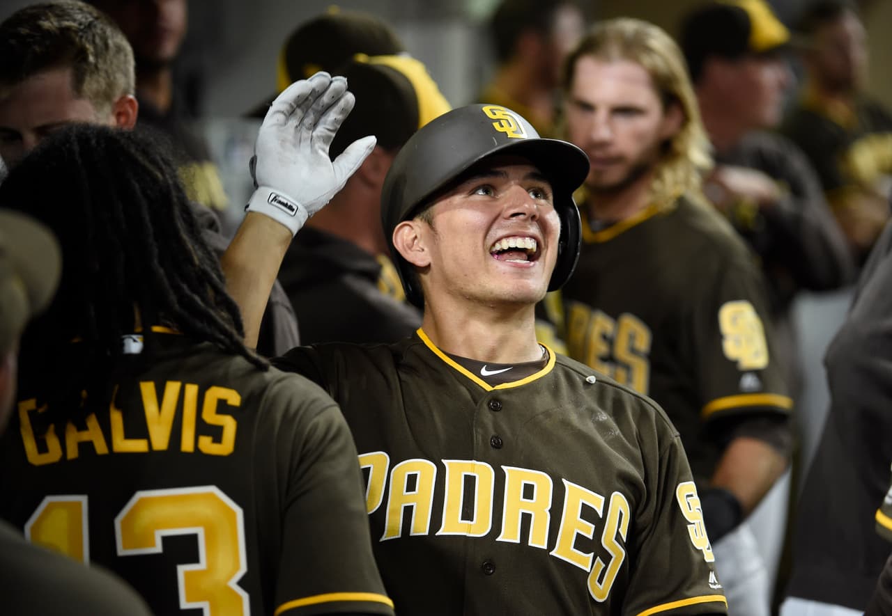 SAN DIEGO, CA - AUGUST 31: Luis Urias #9 of the San Diego Padres is congratulated after hitting a two-run home run during the eighth inning of a baseball game against the Colorado Rockies at PETCO Park on August 31, 2018 in San Diego, California. (Photo by Denis Poroy/Getty Images)