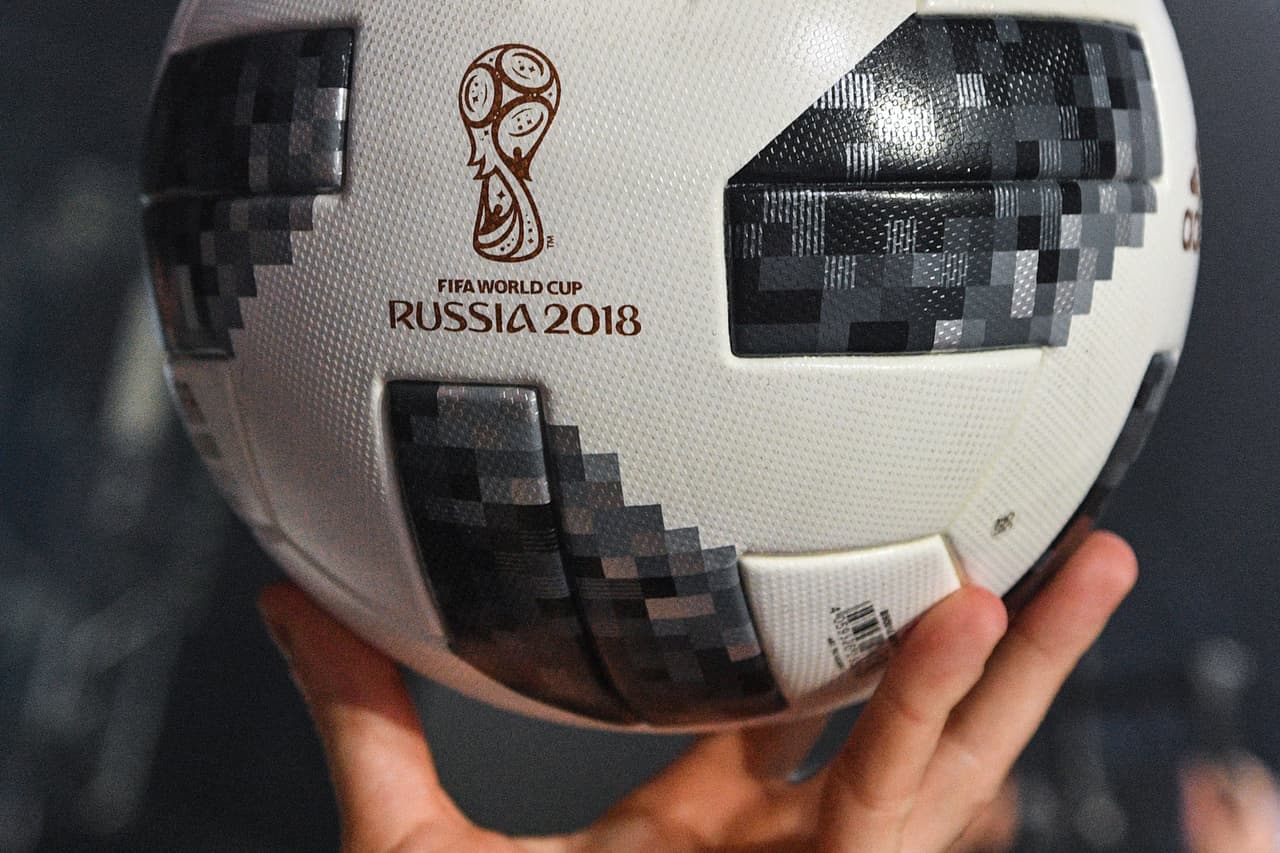 A participant holds the official match ball for the 2018 World Cup football tournament, named "Telstar 18", during its unveiling ceremony in Moscow on November 9, 2017. / AFP PHOTO / Mladen ANTONOV (Photo credit should read MLADEN ANTONOV/AFP/Getty Images)