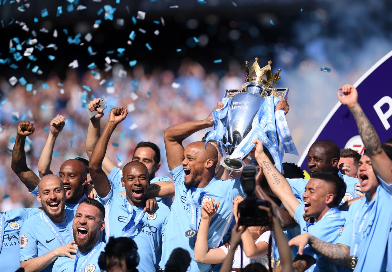 MANCHESTER, ENGLAND - MAY 06: Vincent Kompany of Manchester City lifts the Premier League Trophy as Manchester City celebrate winning the Premier League Title during the Premier League match between Manchester City and Huddersfield Town at Etihad Stadium on May 6, 2018 in Manchester, England. (Photo by Laurence Griffiths/Getty Images)