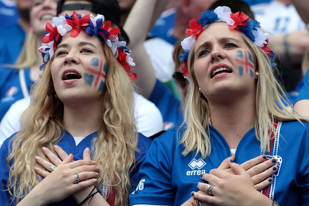 Iceland supporters cheer during the Euro 2016 group F football match between Iceland and Austria at the Stade de France stadium in Saint-Denis, near Paris on June 22, 2016. / AFP / KENZO TRIBOUILLARD (Photo credit should read KENZO TRIBOUILLARD/AFP/Getty Images)