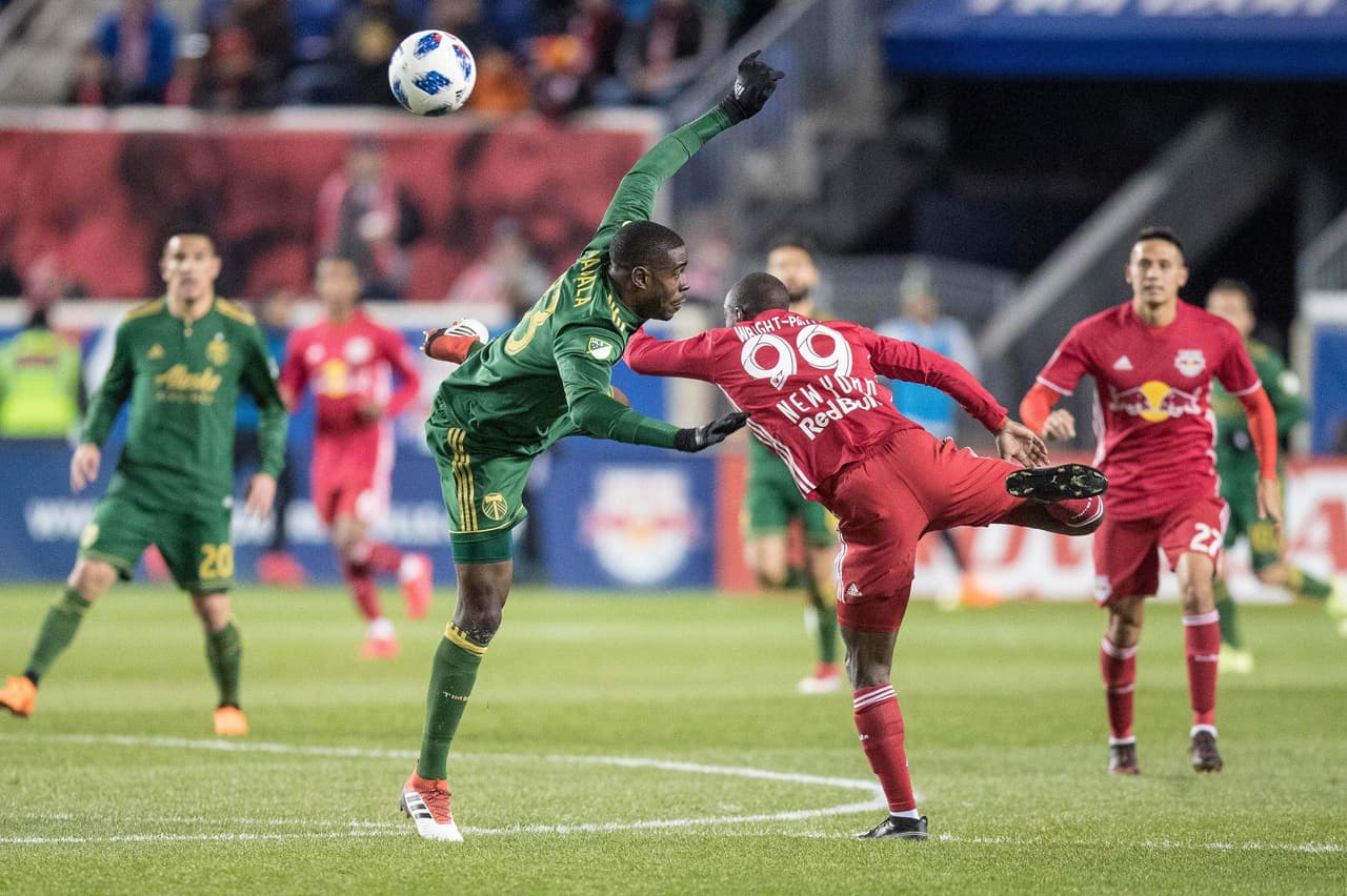 Mar 10, 2018; Harrison, NJ, USA; New York Red Bulls forward Bradley Wright-Phillips (99) heads the ball against New York Red Bulls midfielder Aaron Long (33) during the second half at Red Bull Arena. Mandatory Credit: Vincent Carchietta-USA TODAY Sports