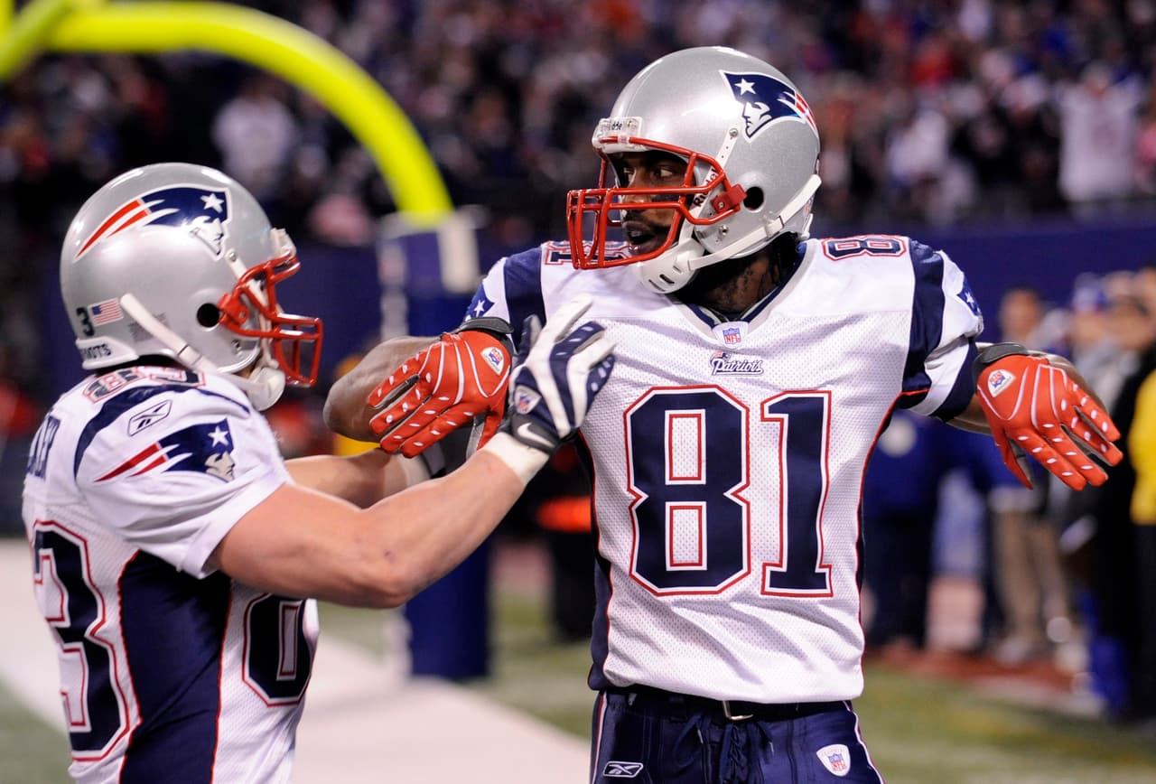 **FILE** New England Patriots wide receiver Randy Moss (81) celebrates with his teammate Wes Welker after catching a 65-yard touchdown pass from quarterback Tom Brady in the fourth quarter of an NFL football game at Giants Stadium in East Rutherford, N.J., in this Dec. 29, 2007 file photo. Brady broke the single-season record with his 50th touchdown pass and Randy Moss broke the single-season record with his 23rd touchdown catch on the play. The Patriots defeated the Giants 38-35 to become the first team to go 16-0 in the regular season and the first since the 1972 Miami Dolphins to go through a full schedule without a loss. (AP Photo/Bill Kostroun, File)